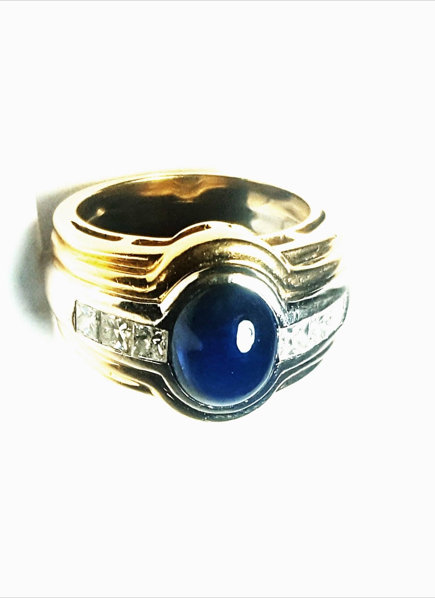 Combining precious stones with diamonds is always a winning design.  This fabulous 18 karat yellow gold ring features an oval cabochon sapphire measuring 8mm x 10mm, weighing in at 3.15 carats.  An insert of 18 karat white gold, in the center of the