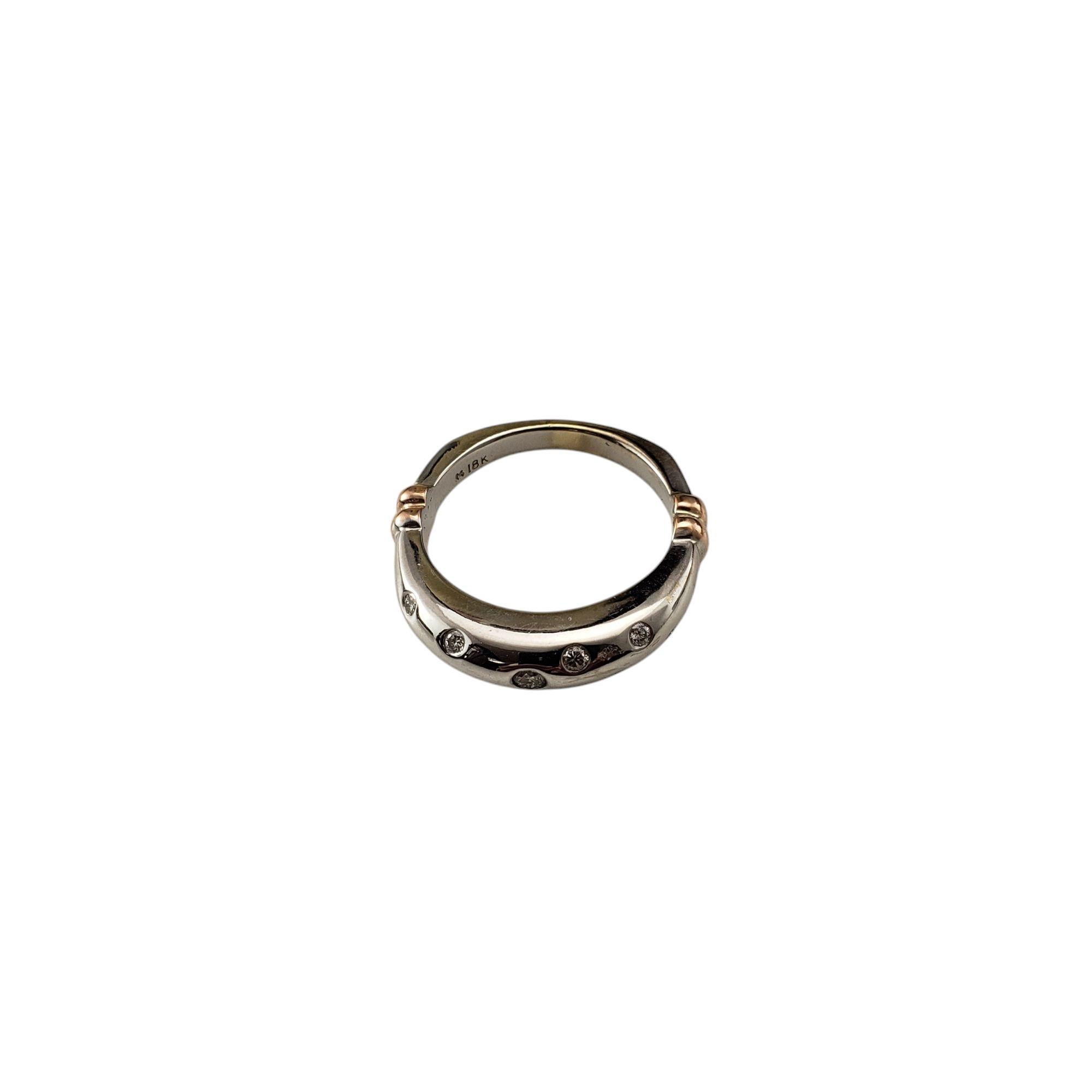 18K Two Tone Gold and Diamond Ring Size 6.25 

This elegant ring features nine round brilliant cut diamonds set in polished 18K white gold. Accented with 14K yellow gold on band. Width: 4 mm. Width: 2.5 mm.

Approximate total diamond weight: .18 -