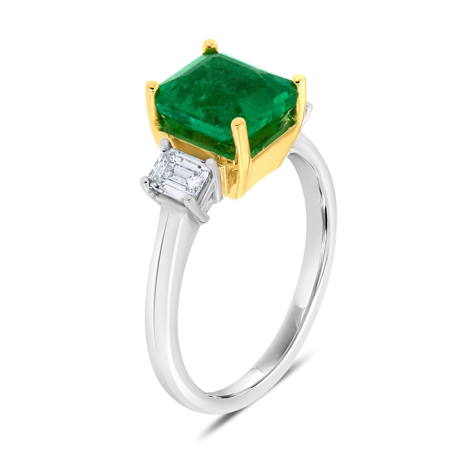 This Classic Three-stone ring features a 2.31 Carat Ethiopian emerald flanked by two perfectly matched emerald-shaped natural diamonds in the total weight of 0.44 carat. Our clients love Ethiopian emerald due to their exceptional luster and color
