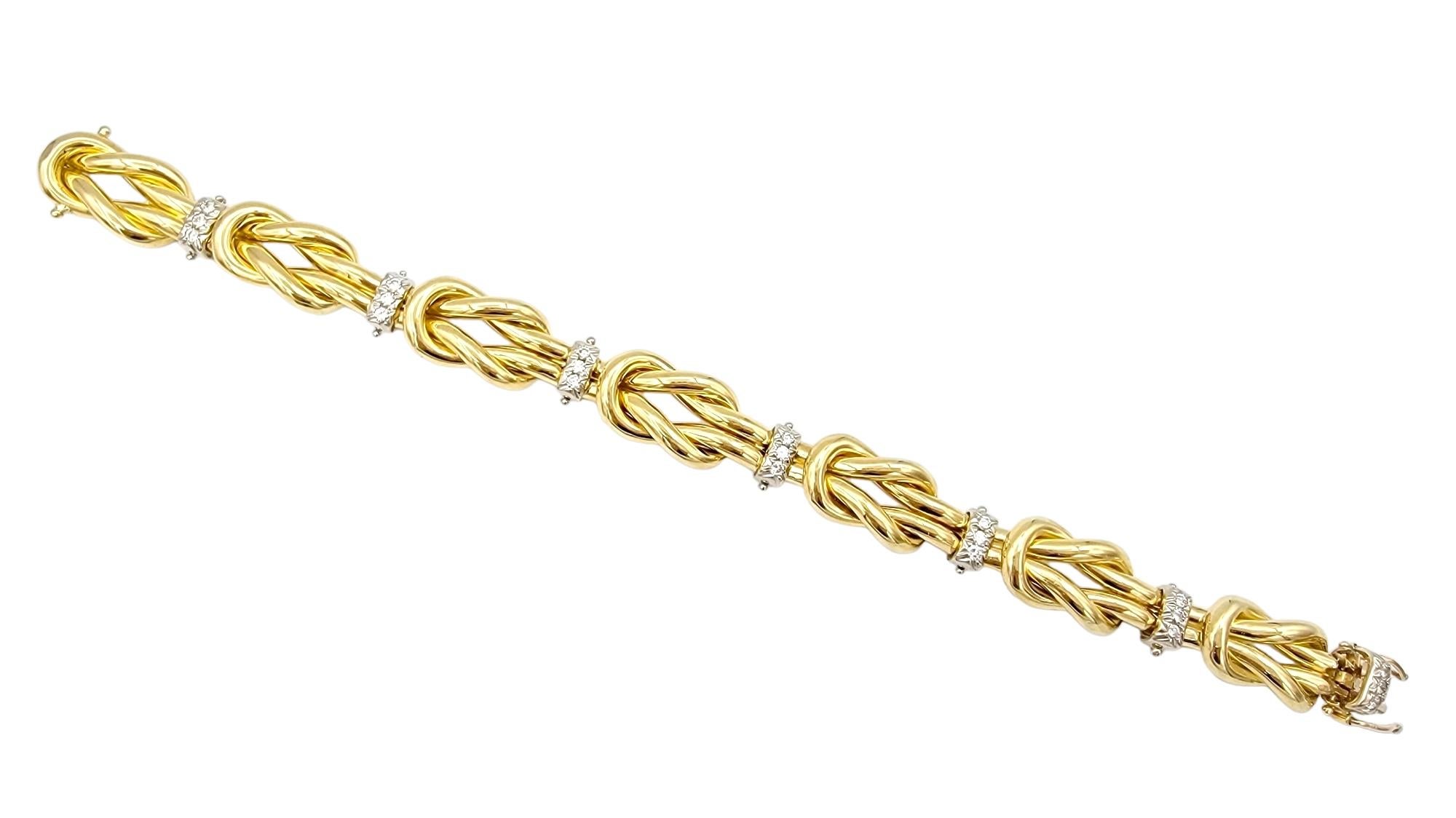 This exquisite 18 karat gold link bracelet is a true testament to the art of jewelry design, combining elegance and boldness in this larger statement bracelet that demands attention. The central theme of this bracelet is the intricate love knot