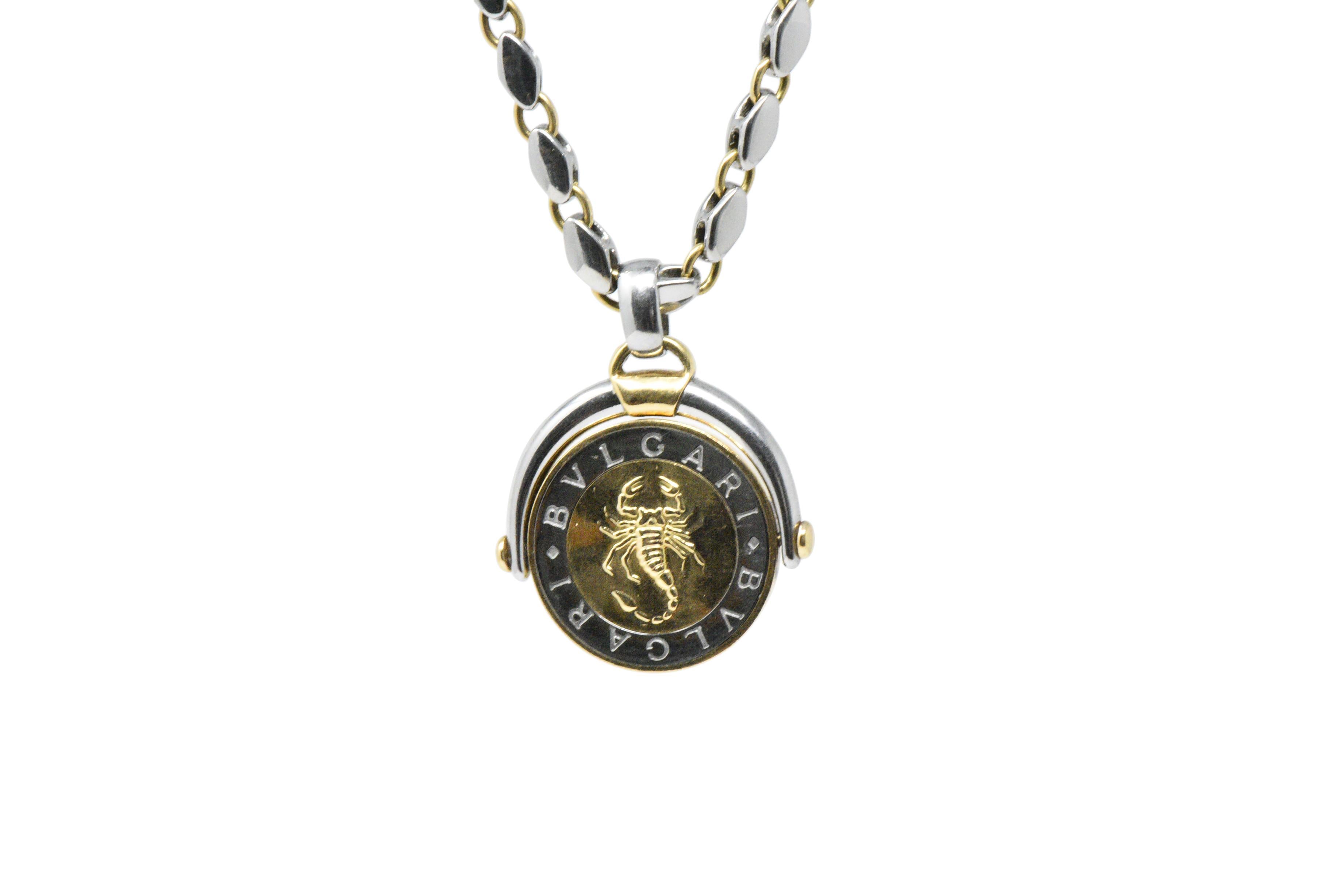 Rotating disc charm, in 18K yellow and white gold, the yellow gold center depicting a scorpion, the symbol for Scorpio in the modern zodiac

On a 18K yellow and white gold chain, completed by a 