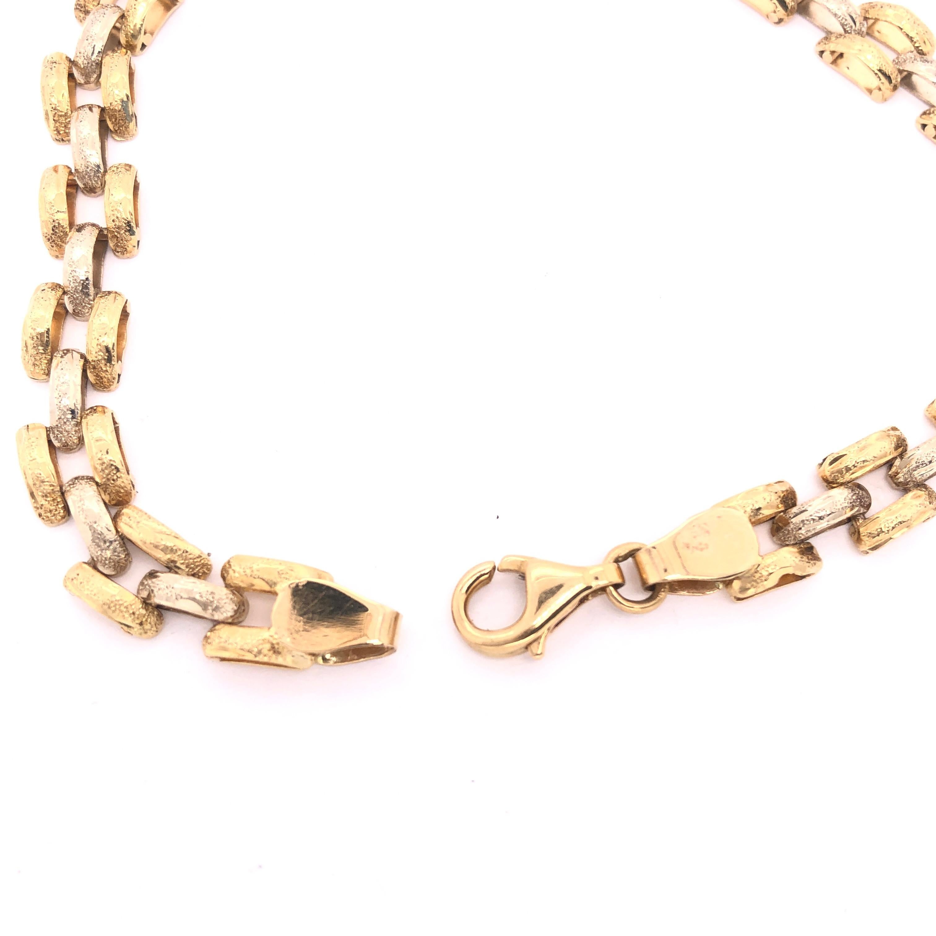 18 Karat Two Tone Yellow And White Gold Fancy Link 8.5 Inch Bracelet
12 grams total weight.
7 mm wide.