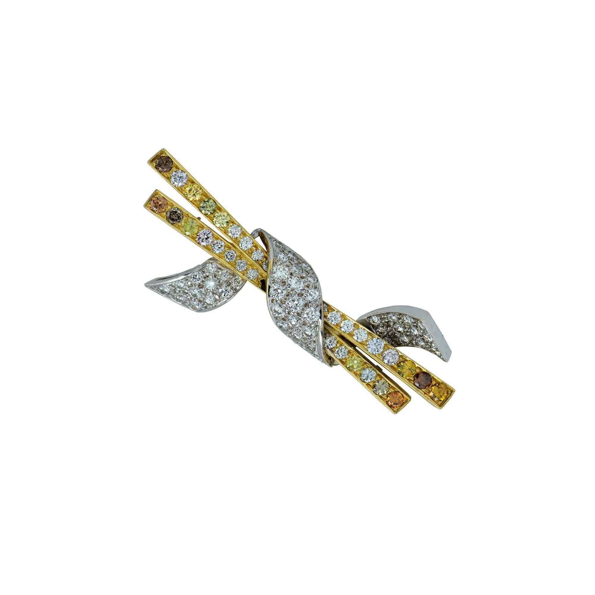 This gorgeous 18k Two Toned Yellow and White Gold and Fancy Colored Diamond Broach Pin features an eclectic mix of 76 white and fancy colored diamonds, ranging from electric yellows to vibrant pinks and greens, weighing approximately 3.6 carats