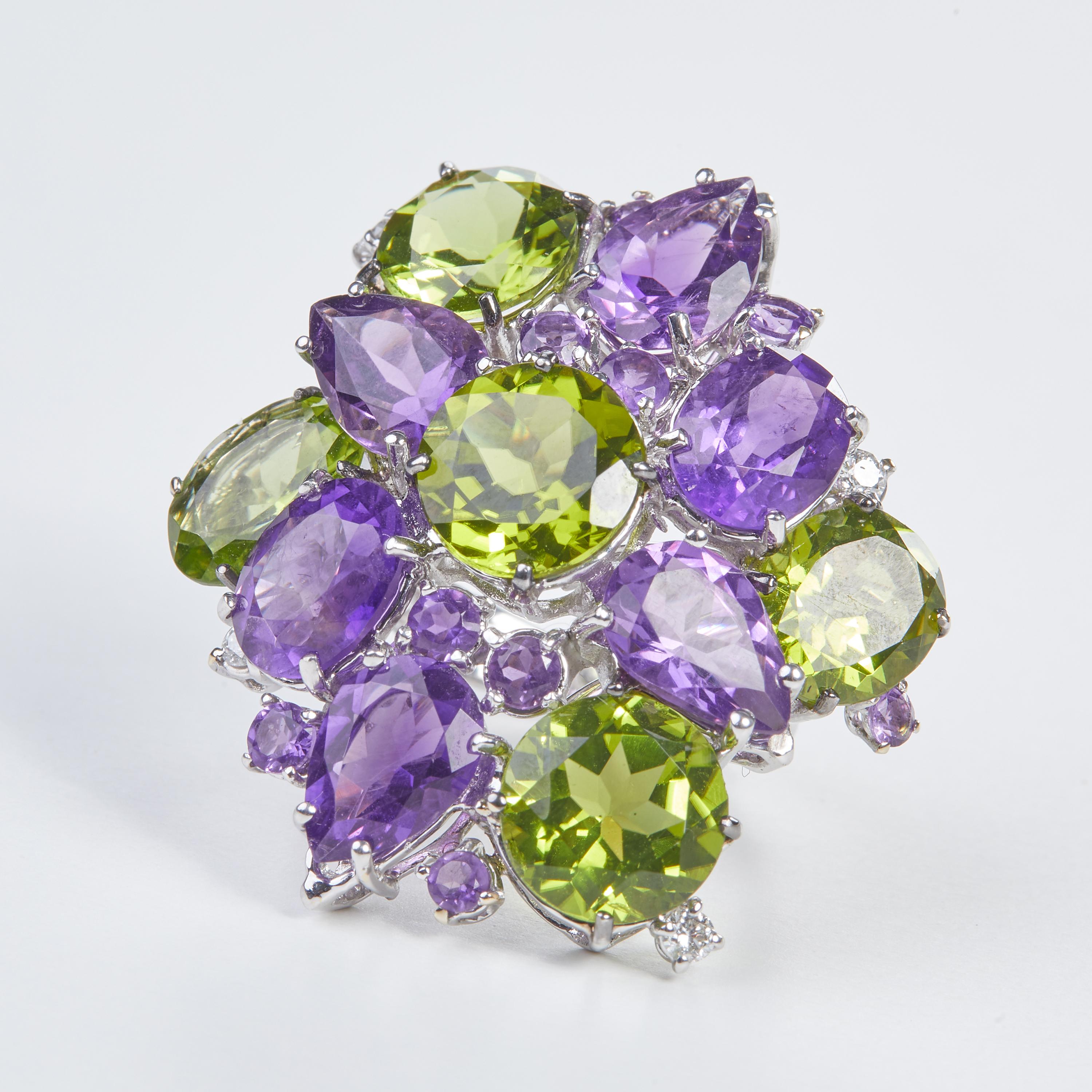 18 Karat WG Diamond Peridot and Amethyst Coktail Ring
4  Diamonds 0,25 Carat
10 Amethist  1.40Carat
6 Amethyst  9.09 Carat
5 Peridot  14.67 Carat

Founded in 1974, Gianni Lazzaro is a family-owned jewelery company based out of Düsseldorf,