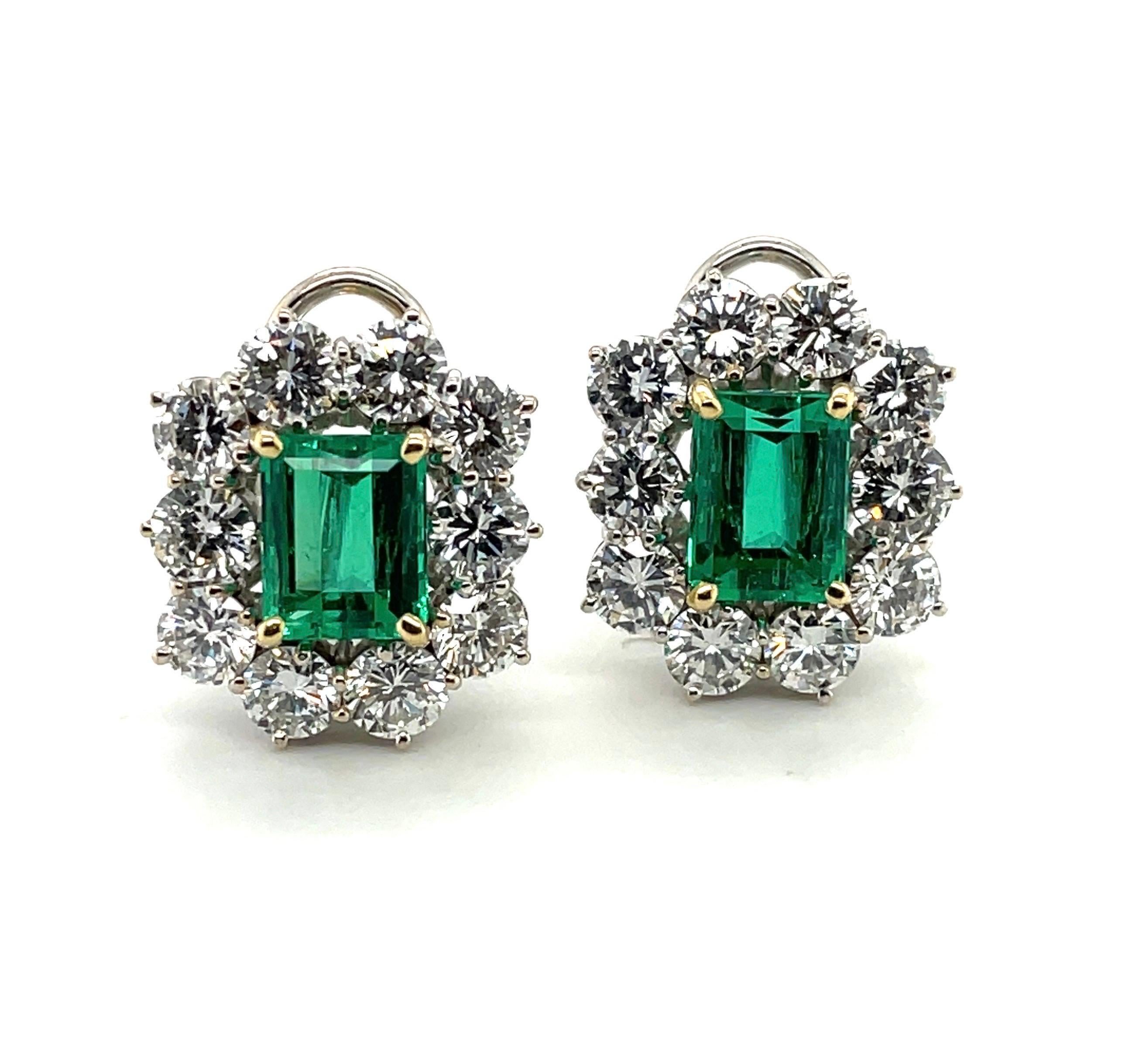 Elegant 18 karat white and yellow gold Colombian emerald and diamond earrings. 

Glamorous earrings of floral design, each set with one octagonal, luminous Colombian emerald of 2.60 carats, resp. 2.37 carats, within a brilliant-cut diamond surround