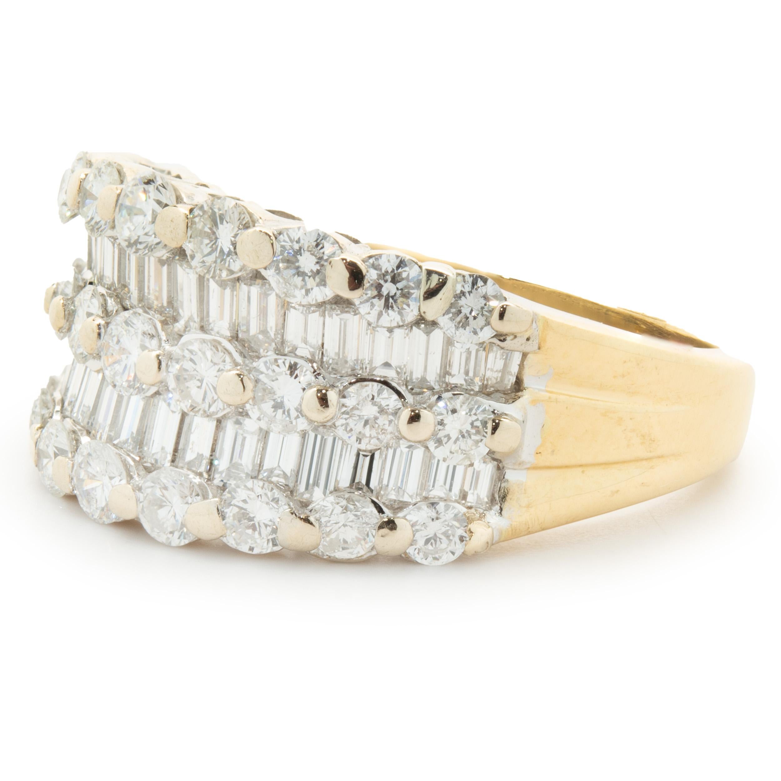 Designer: custom
Material: 18K yellow & white gold
Diamond: 27 round brilliant cut = 2.01cttw
Color: G
Clarity: VS1-2
Diamond: 40 baguette cut = 0.80cttw
Color: G
Clarity: VS1-2
Size: 5.5
Weight: 7.71 grams