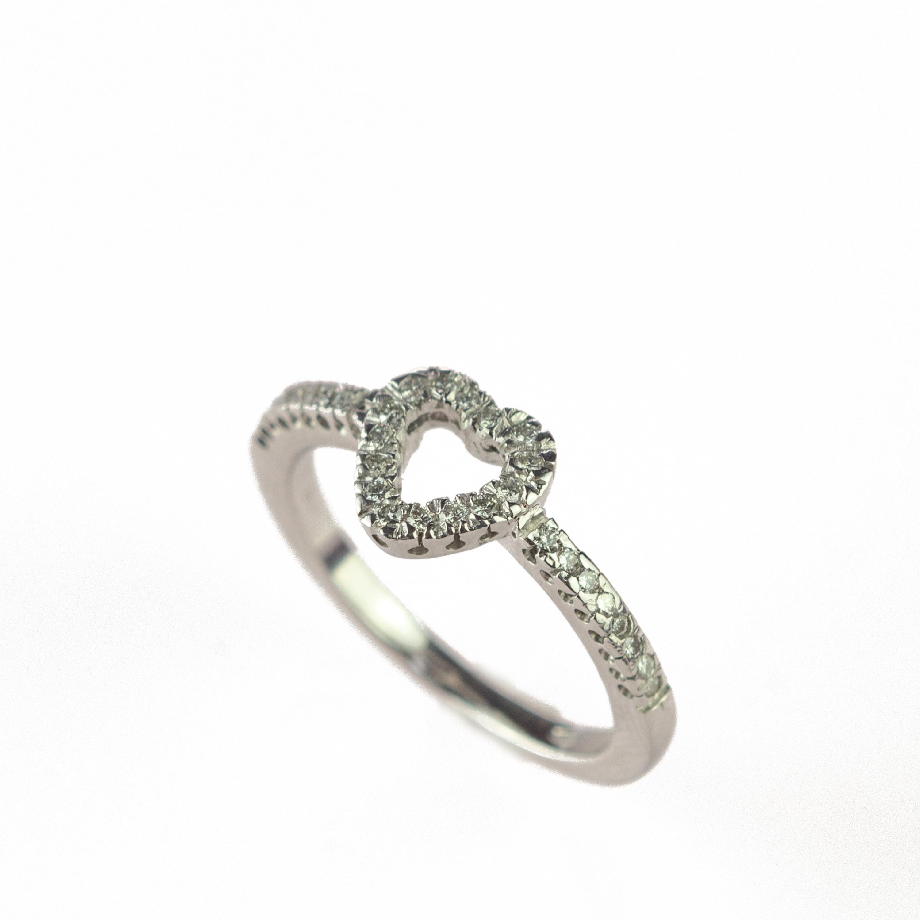 A delicate and sweet ring characterized by its diamonds that come together in a beautiful diamond heart shape embelished with 18k white gold.
 
This ring is inspired by the brilliance of its diamonds that from far away glows with light and glamour,