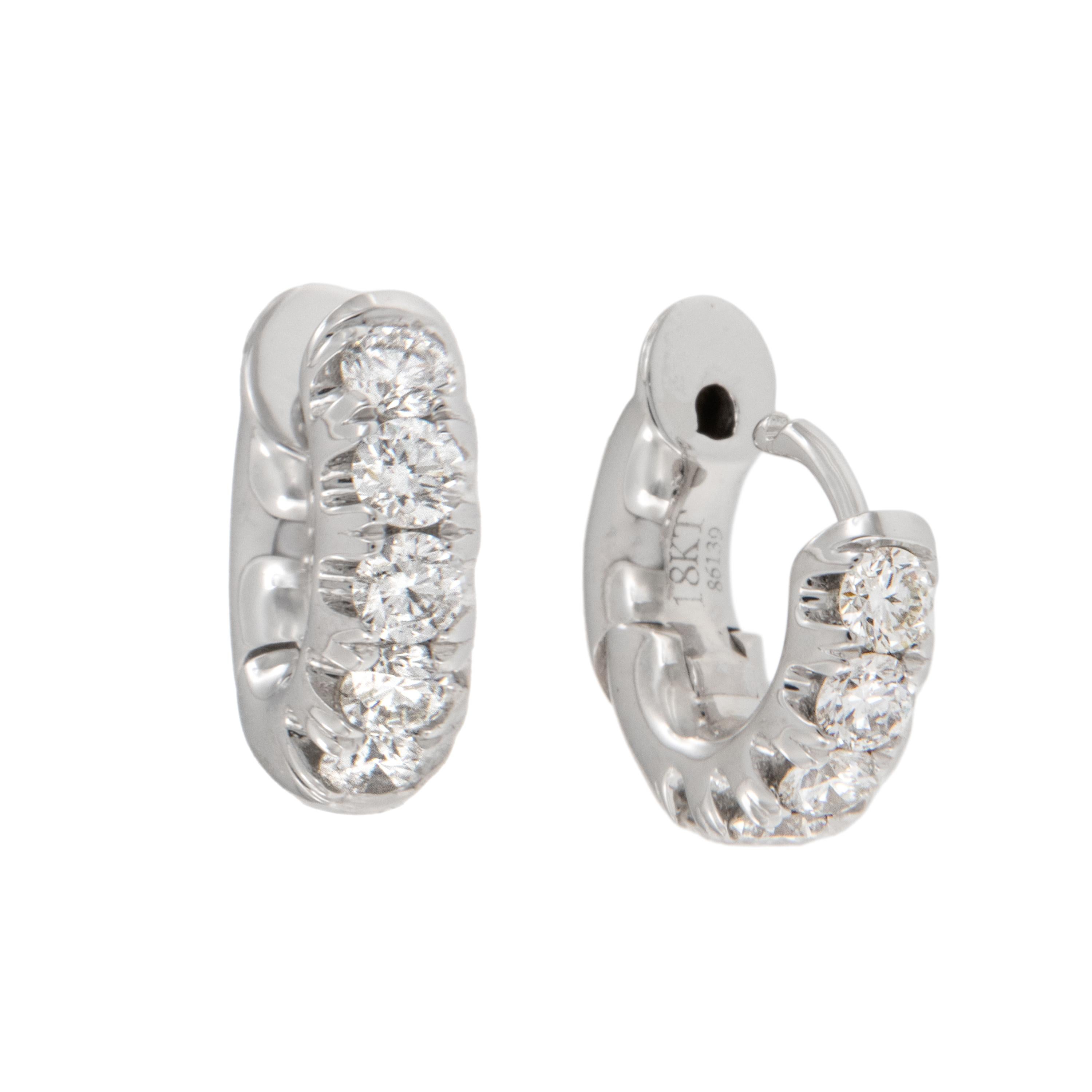 Beautiful split prong diamond earrings you can wear every day! Made from fine 18 karat white gold, these huggy earrings boast 0.50 Cttw. of VS clarity, G-H color diamonds. Being huggy style the hinged earring backs come up to click into the front