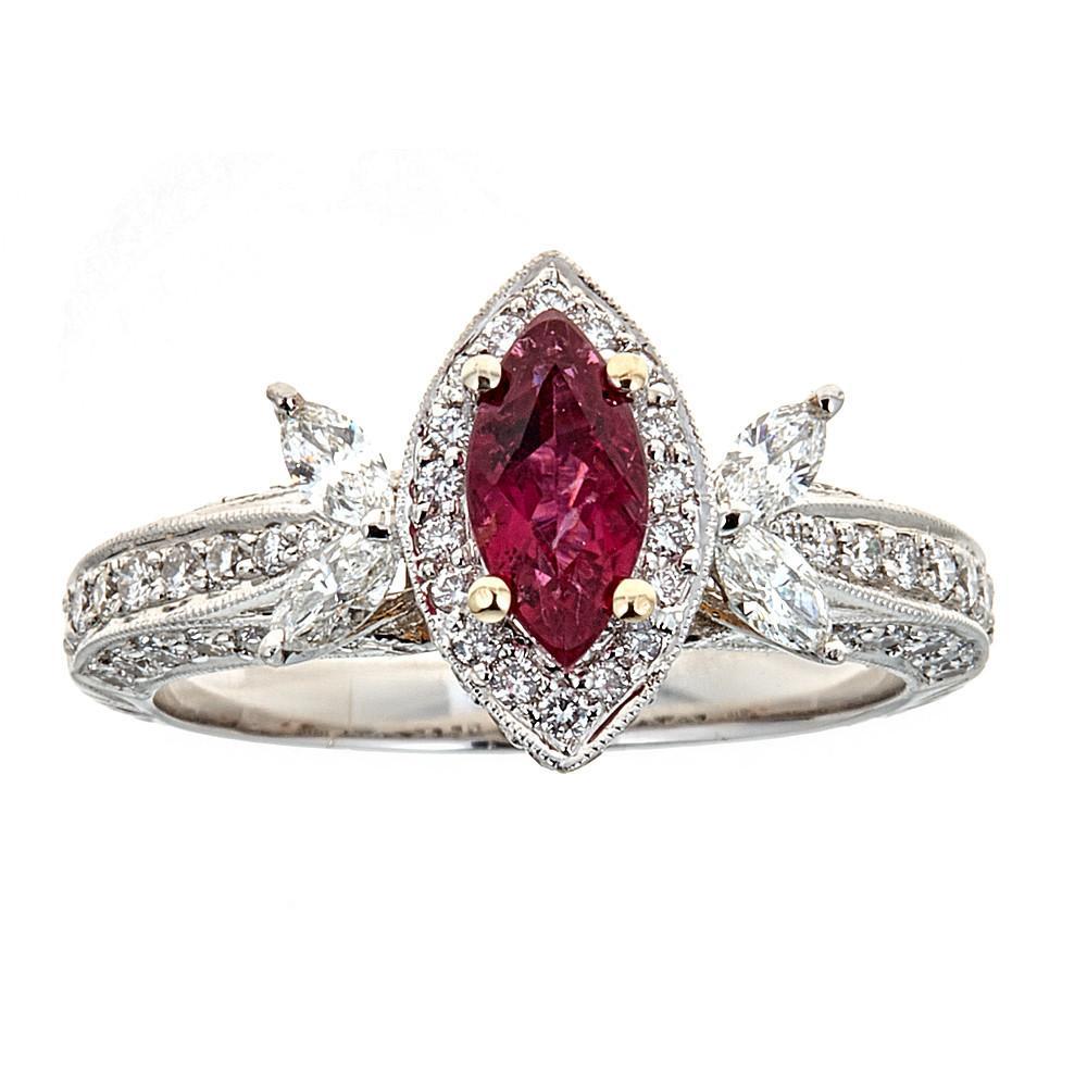18 Karat White Gold 0.60 Carat Ruby and 0.76 Carat Diamond Engagement Ring

Uniquely designed this ring will create a sophisticated look. Marquise cut deep red ruby is set atop of this magnificent ring, surrounded by a glistening set of round
