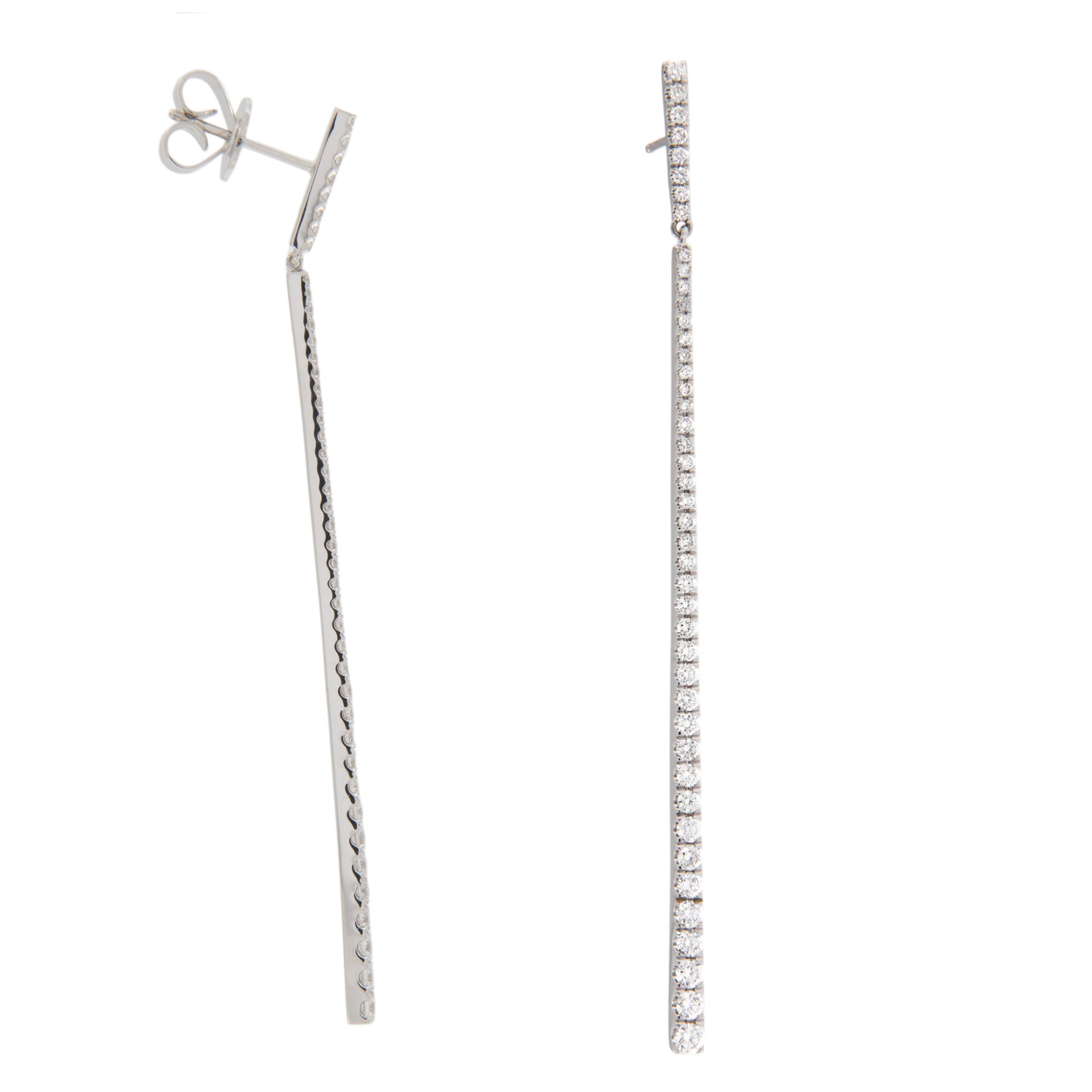 Striking and sleek! These gorgeous earrings are crafted in rich 18 karat white gold accented with 0.97 Cttw fine quality G-VS diamonds in long 2 part dangle stick fashion for a look that moves and sways with you! Made with posts and friction backs