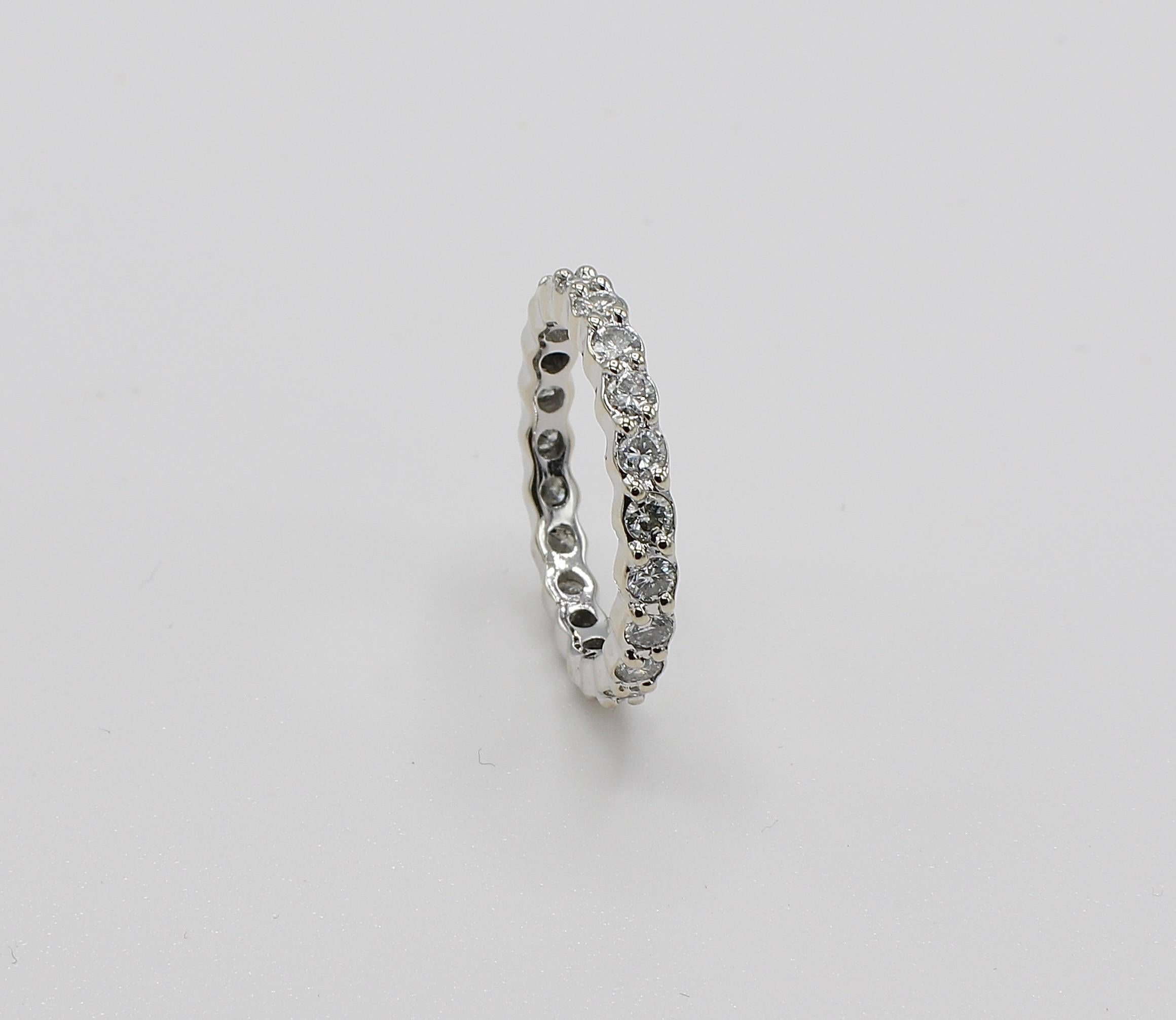 18 Karat White Gold 1 Carat Natural Diamond Eternity Band Ring Size 4
Metal: 18k white gold
Weight: 2.17 grams
Diamonds: Approx. 1 CTW G-H VS natural diamonds
Size: 4 (US)
Band is 2.5 mm wide 
