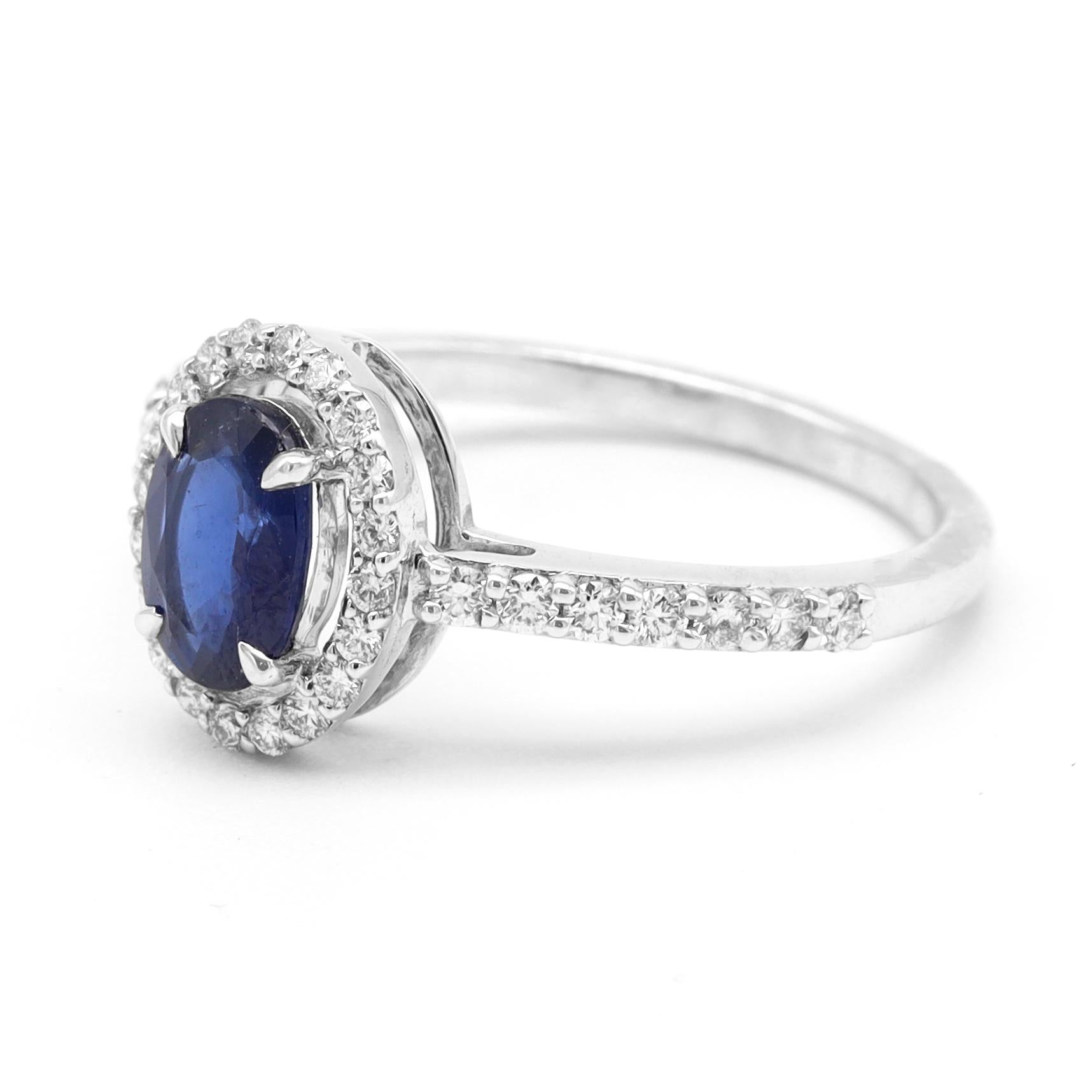 18 Karat White Gold 1.00 Carat Blue Sapphire and Diamond Halo Cluster Ring

This classic royal blue sapphire and diamond halo ring is palatial. The midnight blue sapphire oval prong-set is surrounded with the evenly gaped single row of grain set