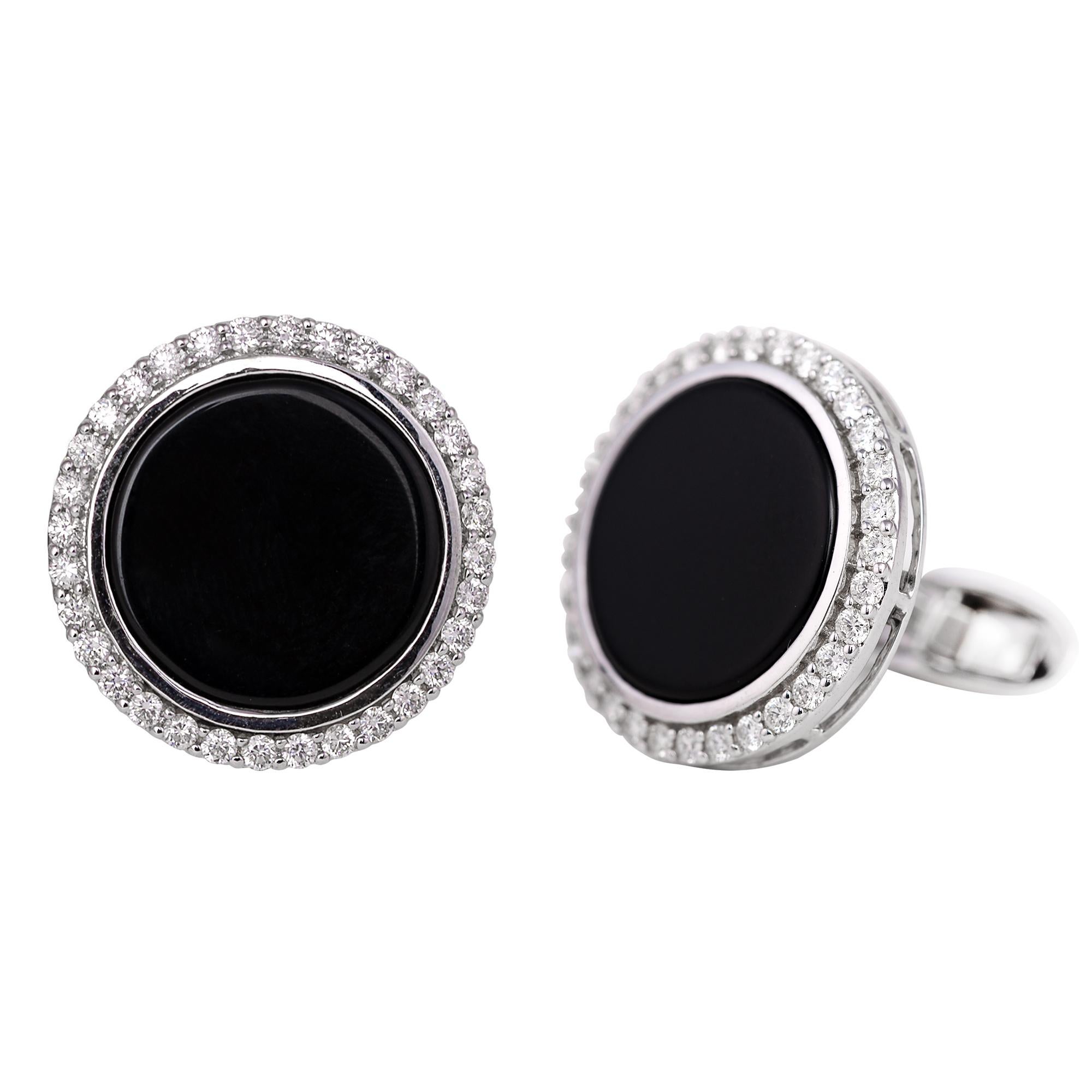 18 Karat White Gold 1.10 Carat Diamond and Black Onyx Cufflinks
This magnificent pitch black onyx and diamond cluster cufflink is timeless. The center solitaire curricular flat black onyx in closed bezel setting is glorified with the single row of