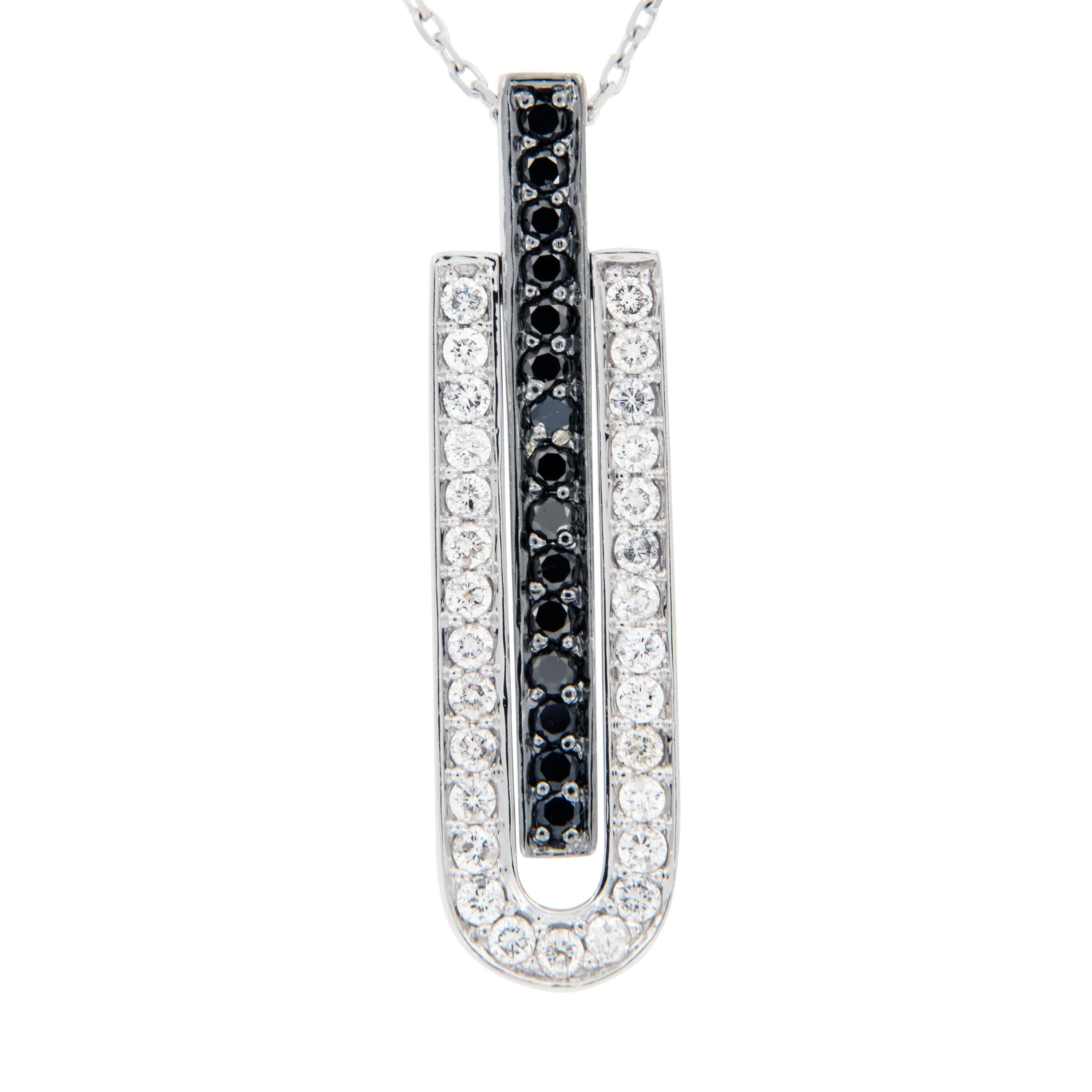 Black & white goes with everything! This unique piece looks fantastic all dressed up for a black tie event as well as it does for less formal ones. It is hinged with the center section set with black diamonds moving freely from the outer white