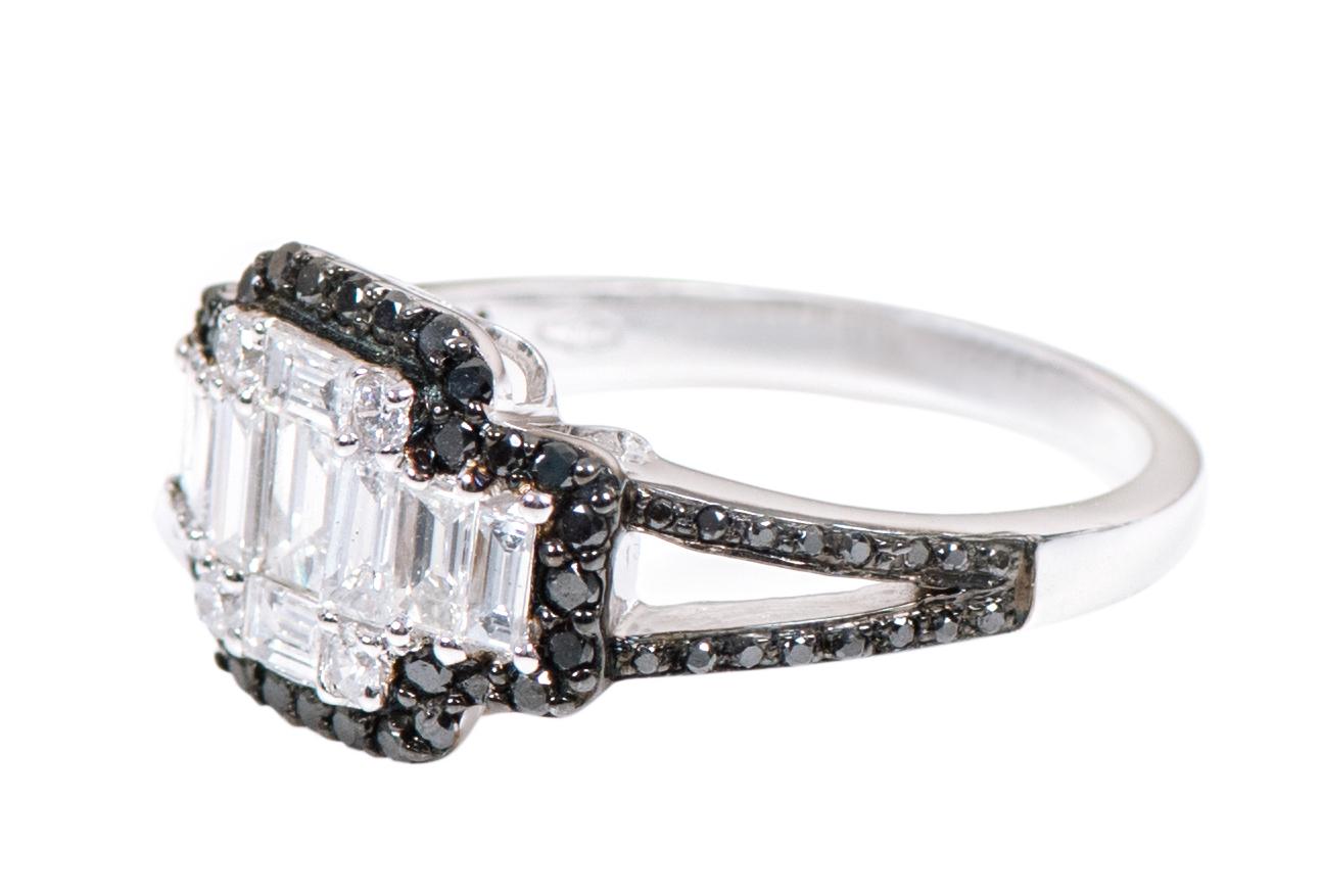 18 Karat White Gold 1.25 Carat White and Black Diamond Invisible Setting Cluster Ring

This extraordinary jet black diamond and invisible set emerald cut diamond ring is magnificent. The center invisible setting diamond emerald cut is a crafty