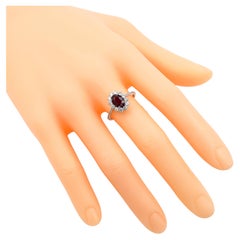 18 Karat White Gold 1.35 Carat Deep Red Ruby Oval-Cut and Diamond Cluster Ring