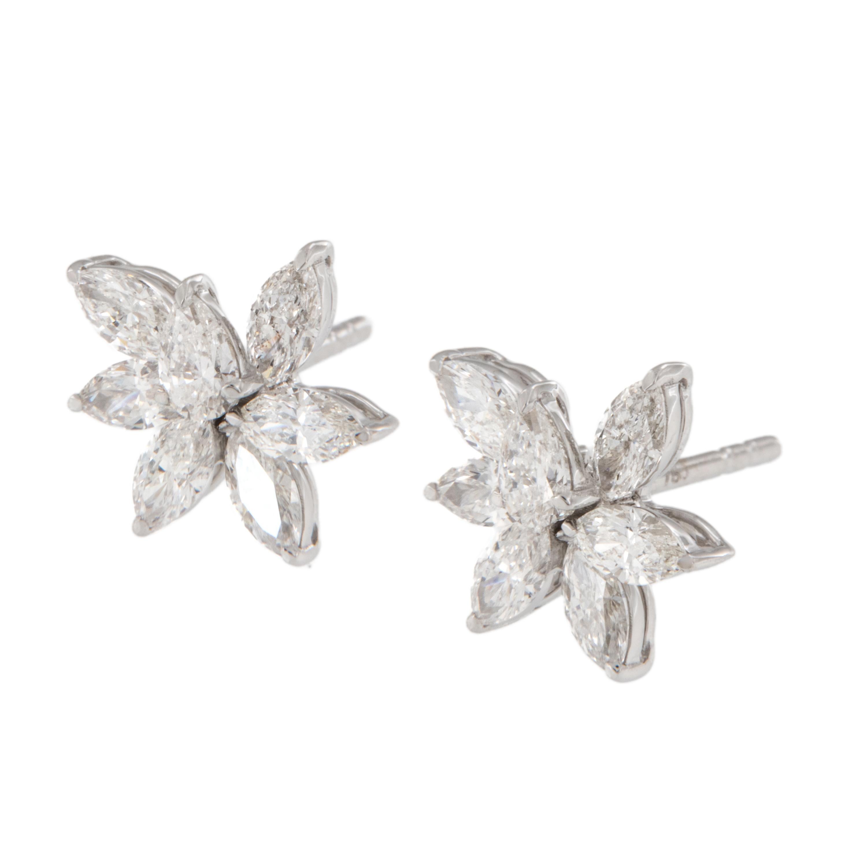 Crafted from fine 18 karat white gold, these lovely floral spray diamond stud earrings look beautiful adorned on your ears. With 1.40 Cttw of marquise & pear shape diamonds (VS-SI, G-H) making a floral bouquet on each ear lobe to set off your