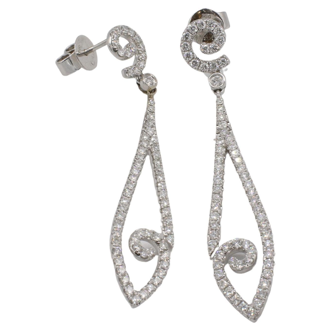 18 Karat White Gold 1.50 Carat Natural Diamond Dangle Drop Earrings 
Metal: 18k white gold
Weight: 6.6 grams
Diamonds: Approx. 1.50 CTW F-G VS round natural diamonds
Length: 2.15 inches
Width: 0.75 inches
TDD 111204-1
