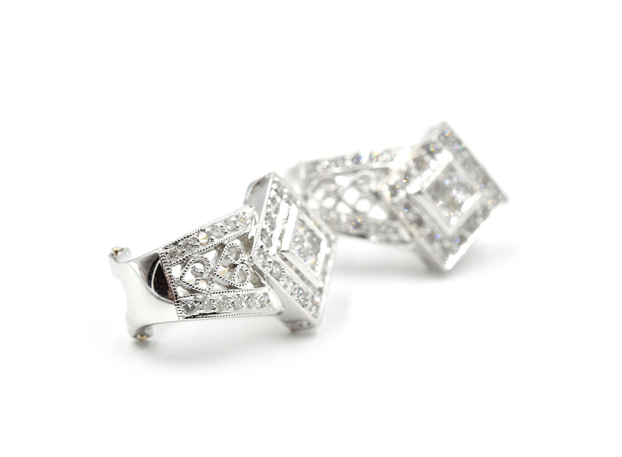 This pair of earrings are so dazzling it is unbelievable when seen in person! Each vintage designed earring is made in 18k white gold and set with quad princess cut diamonds in each center stone position. The princess cut diamonds weigh 0.48 carats.