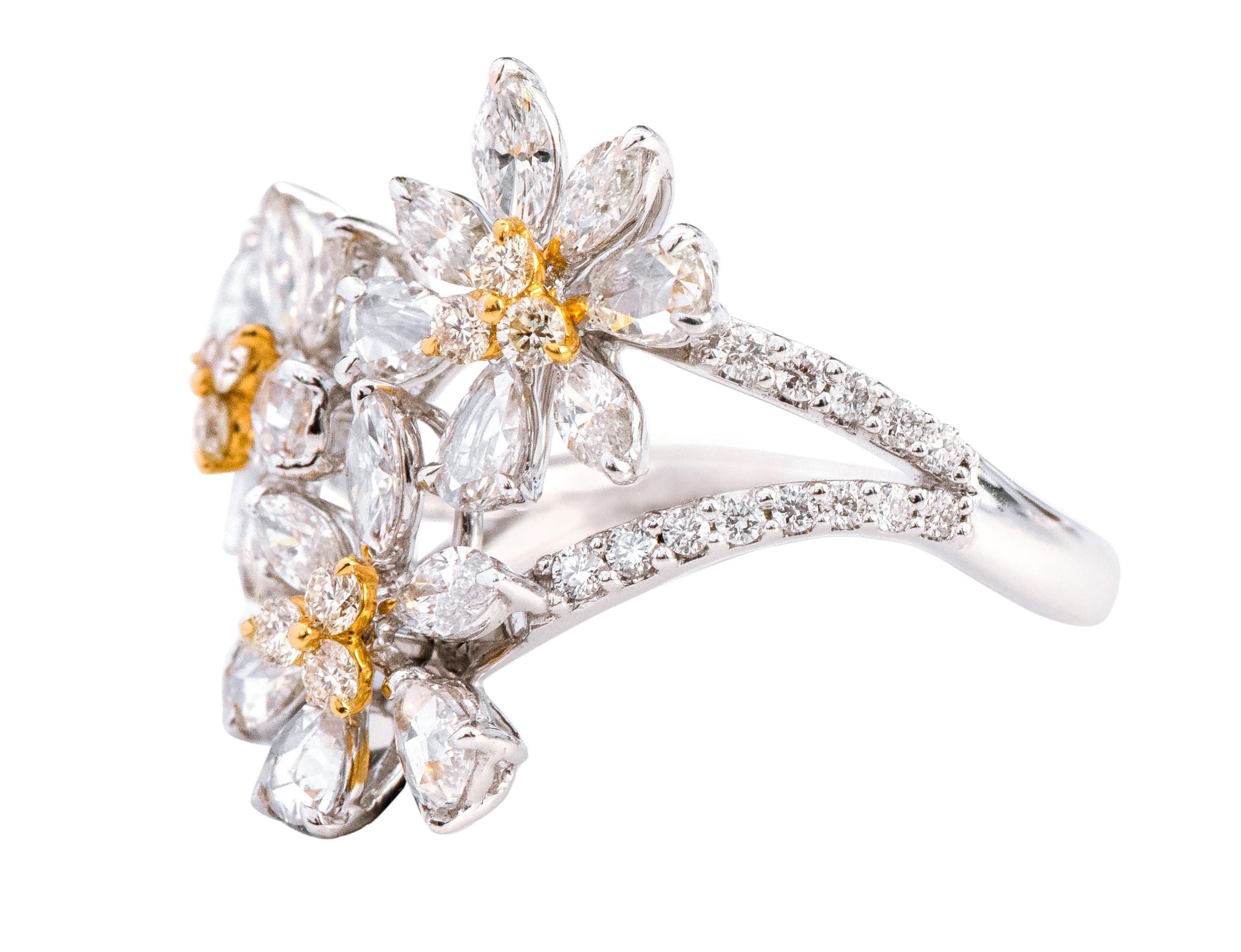 18 Karat White Gold 2.08 Carat Diamond Floral Statement Ring

This exquisite diamond three-flower ring is beyond exemplary. It shows our love for nature and its eminent beauty. The special short and elongated broad rose-cut pear-shaped diamonds with