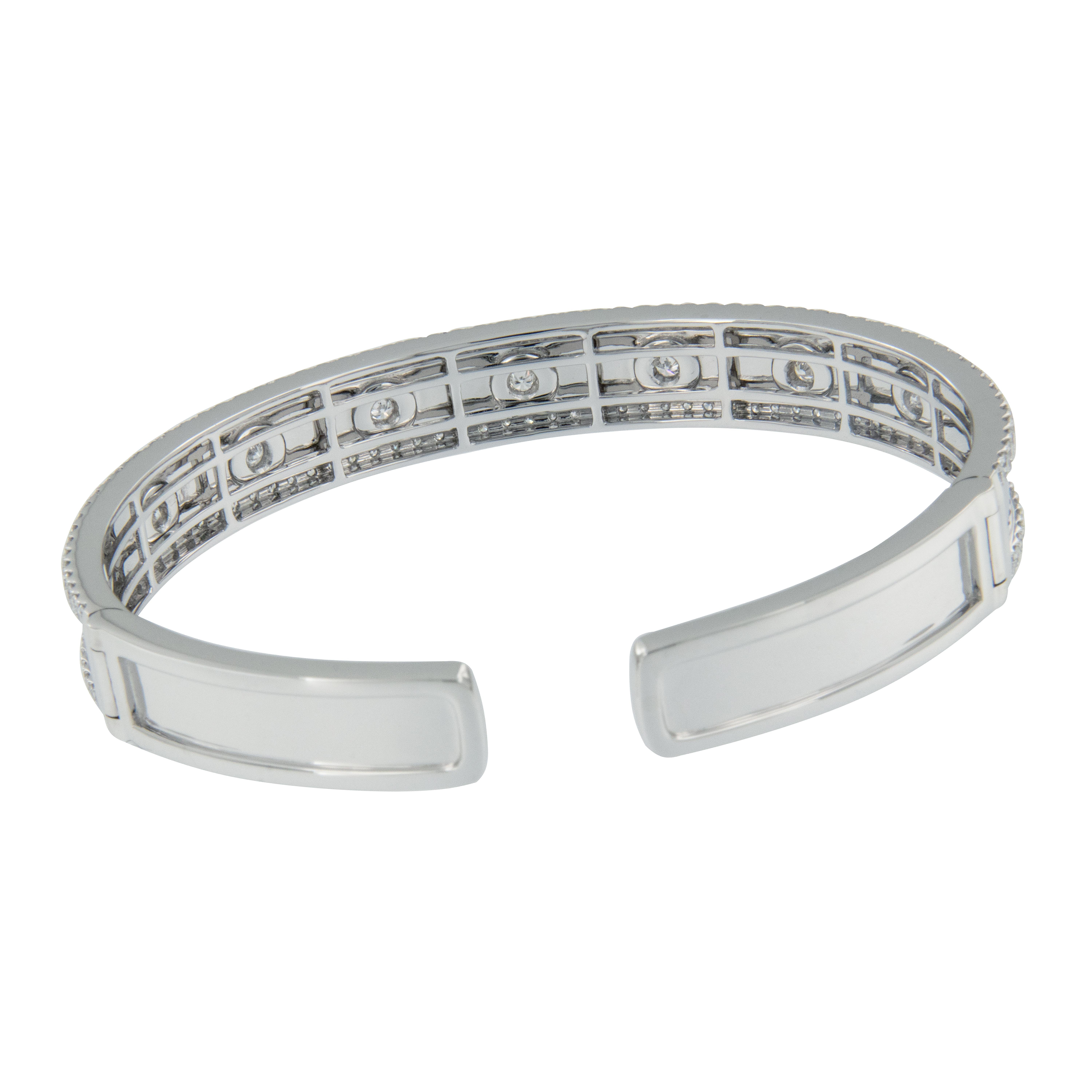 Beautifully executed 18 karat white gold bangle bracelet is perfectly accented with 2.20 Cttw VS clarity, F-G color diamonds expertly burnished set for a smooth look and feel, perfectly 