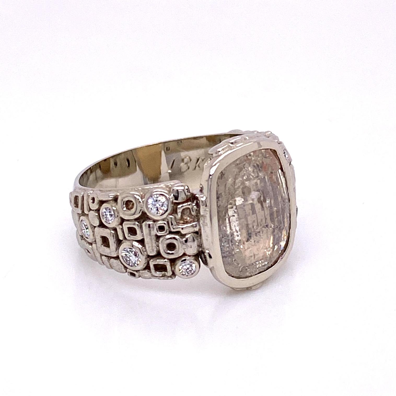 An 18k white gold geometric pattern ring set with a 2.41ct rose cut diamond and .166 total carat weight of F color VS clarity brilliant round cut diamonds. Ring size 6.25. This ring was designed and made by llyn strong.