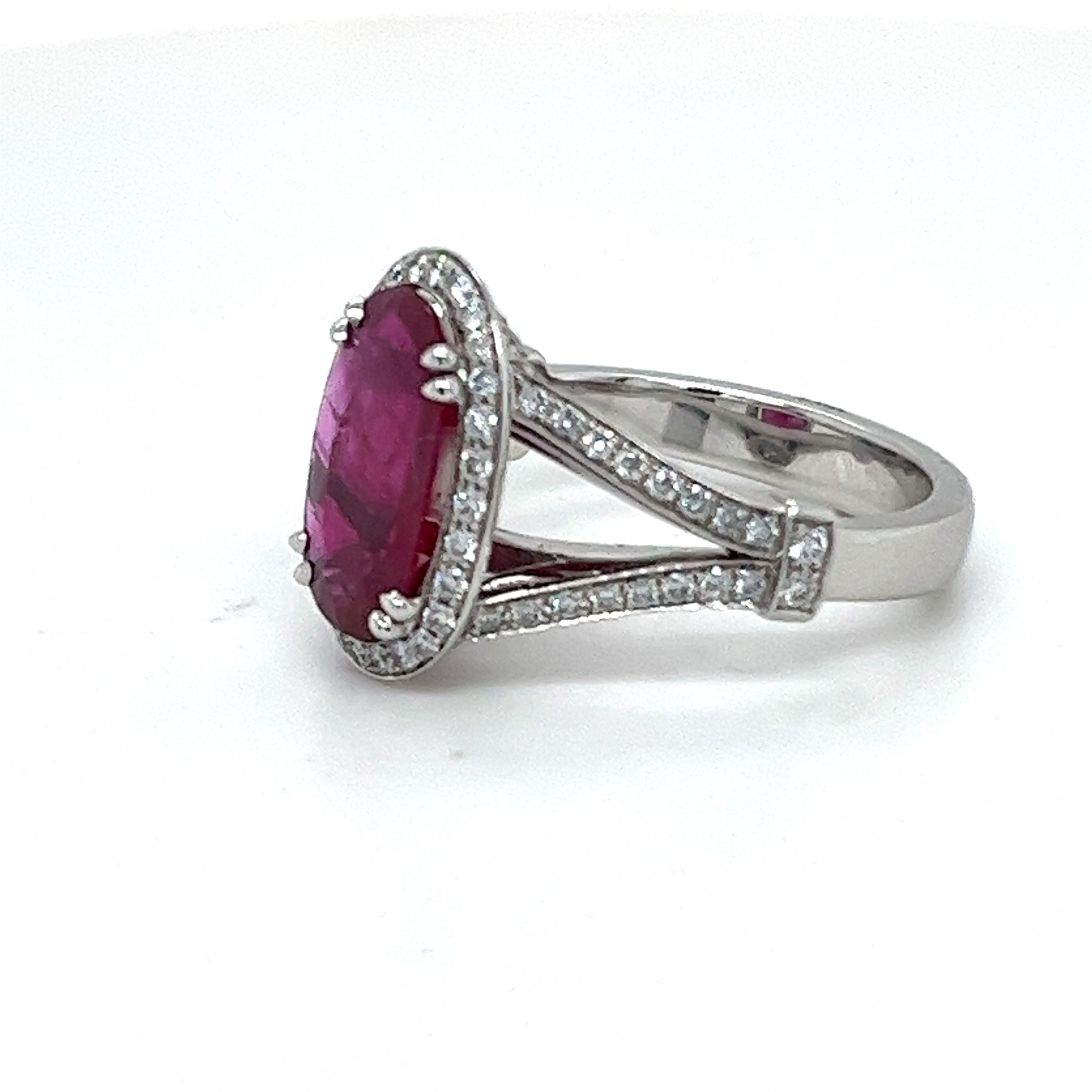 Ravishing 18 karat white gold, 2.75 carats ruby and diamond engagement ring.
Crafted in 18 karat white gold and centering upon an oval, faceted ruby of 2.75 carats. The ruby entourage and the delicate split shank are set with with brilliant-cut