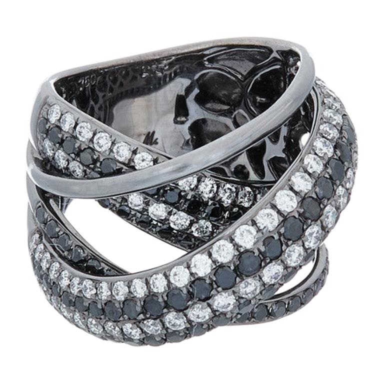 18K white gold criss cross black and white diamond ring, features 3.20 carats of diamonds.  
Ring size 6
