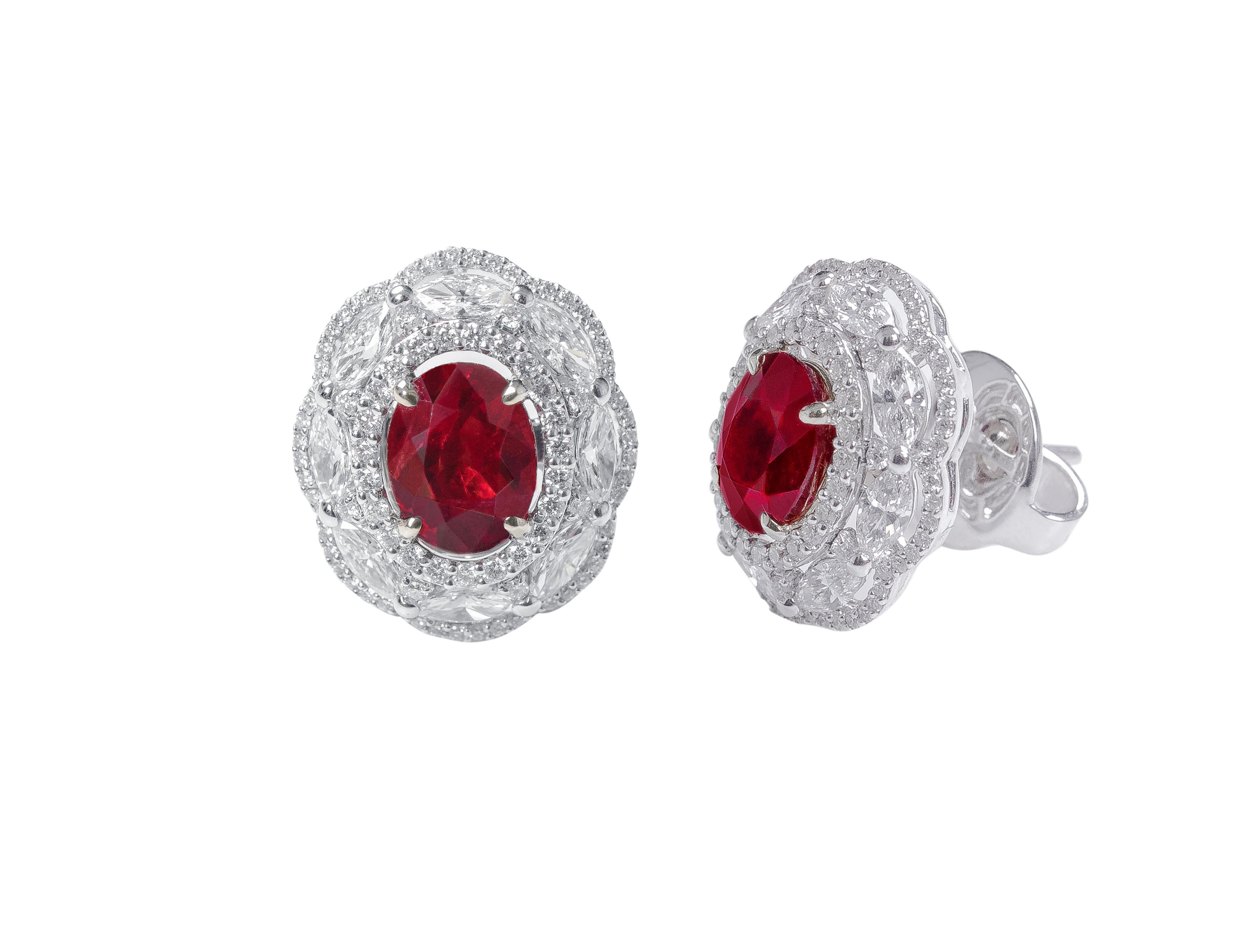 18 Karat White Gold 3.72 Carat Ruby and Diamond Cluster Stud Earrings

This regal pigeon blood ruby oval earring sets the tone for something special. The insensuous blood ruby pair is surrounded by a simple cluster of pave set diamonds and then by