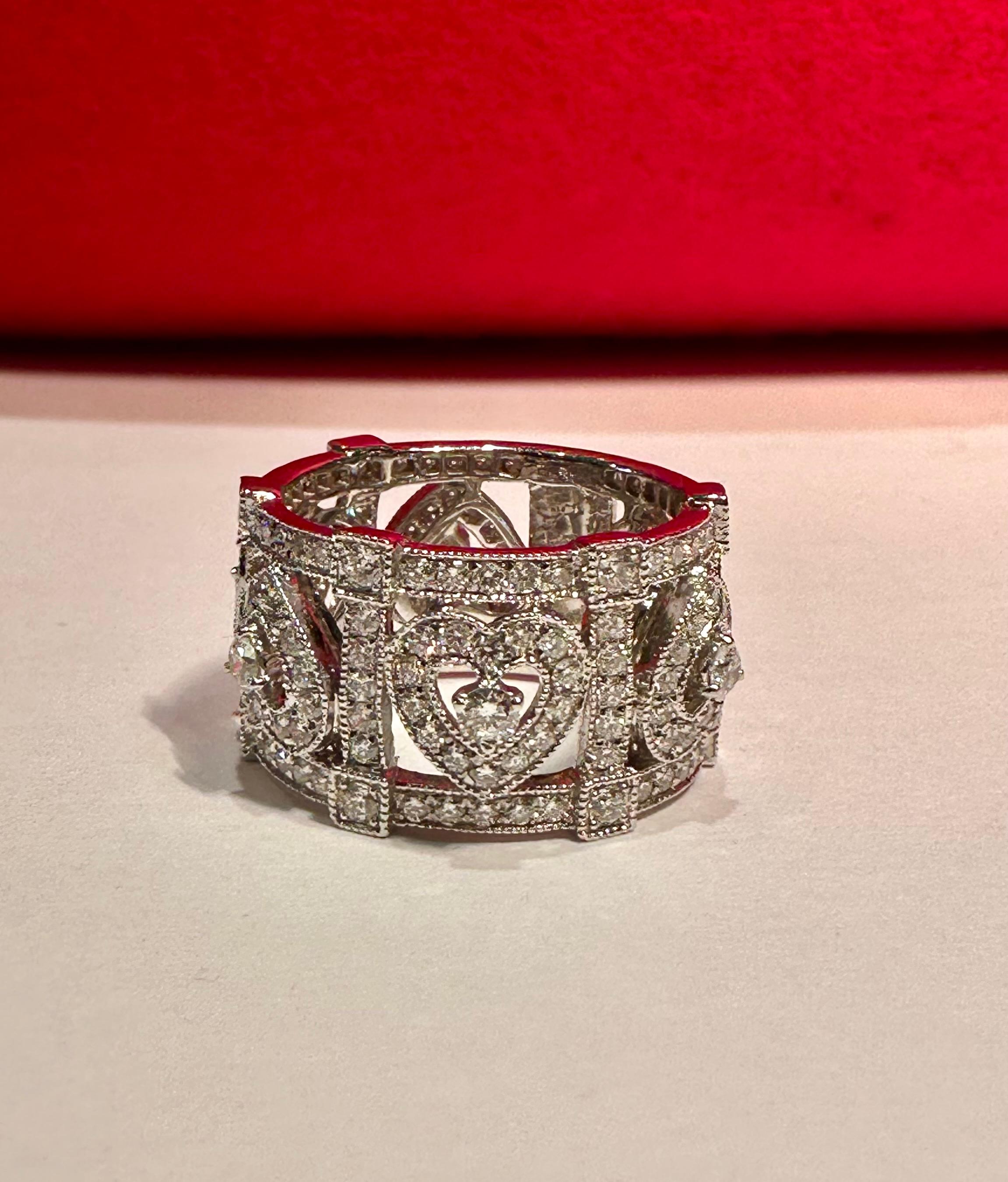 Beautiful, ladies 18 karat white gold custom made 3.75 carat diamond estate eternity like band adorned with round brilliant diamonds, pave and prong set in an elegant heart motif open work pattern.  The diamonds go almost all the way around the ring
