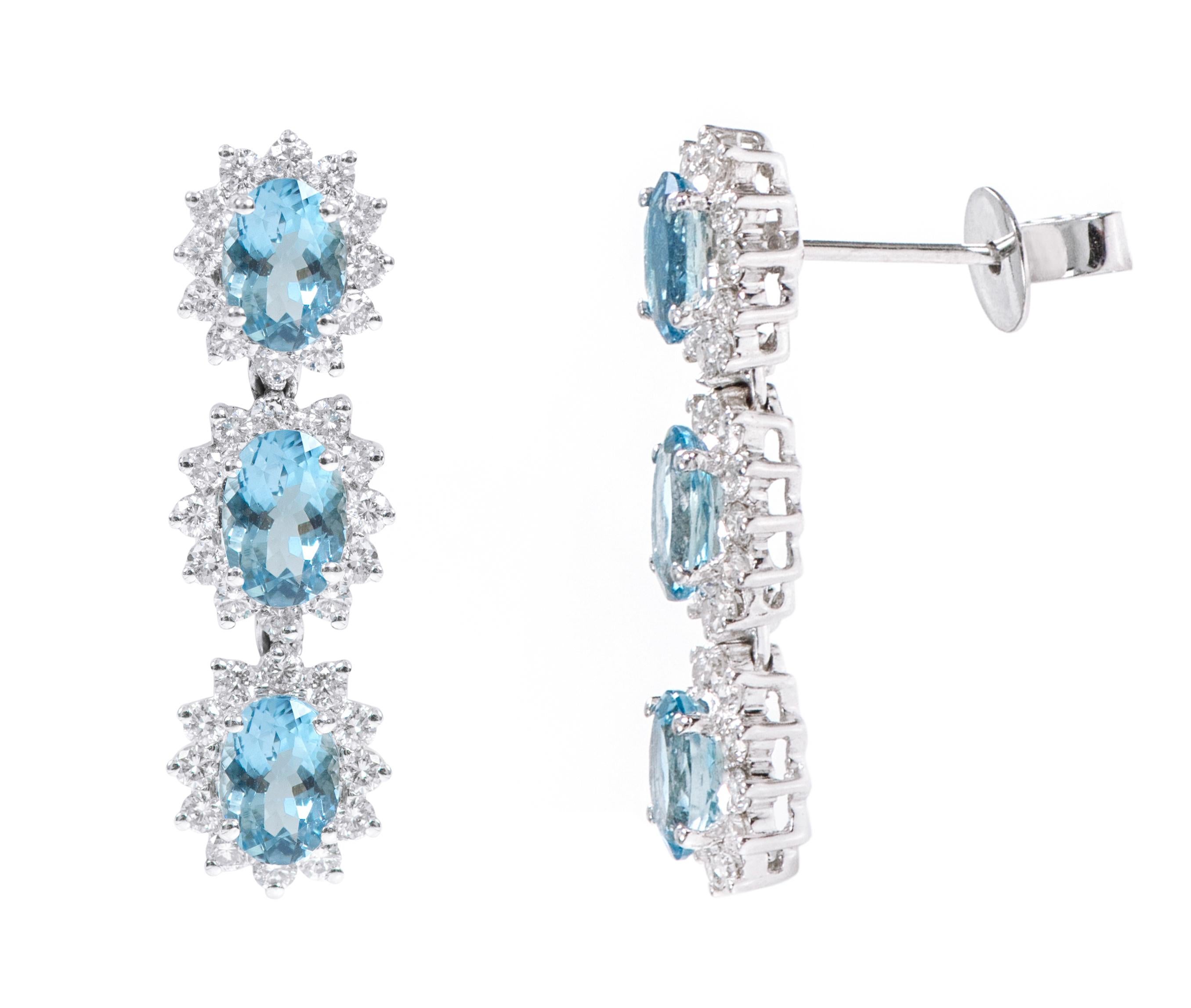 18 Karat White Gold 3.78 Carat Aquamarine and Diamond Cluster Dangle Earrings

This exemplary melody blue aquamarine and diamond long earring is regal. The fantastic three rows of solitaire oval aquamarines are surrounded by the outward-facing open