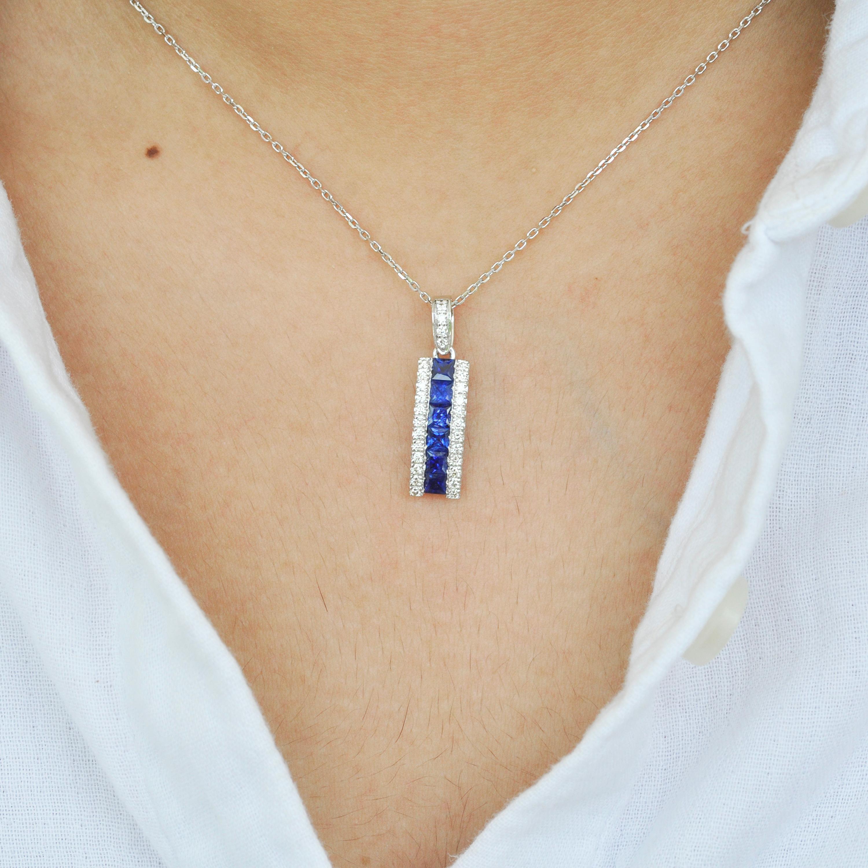 This stunning pendant, crafted in 18-karat white gold, is an elegant showcase of sophistication and meticulous artistry. At its center are six channel-set princess-cut blue sapphires, each precisely cut to a 3mm size. The deep, velvety hue of the