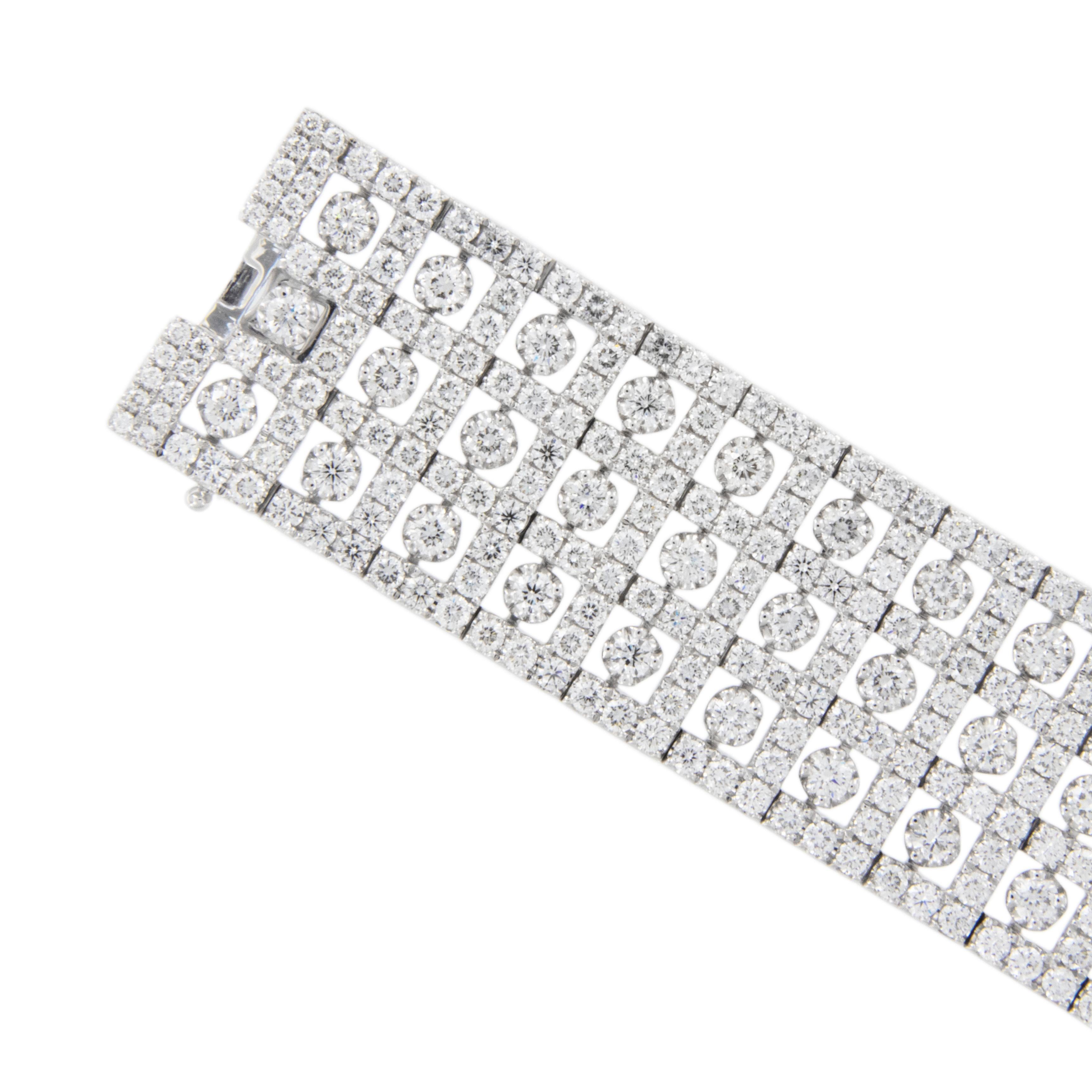 First Class! This show stopping 18 karat white gold wide triple row diamond bracelet boasts 4.59 Cttw  of very fine RBC diamonds (VVS-VS, F-G) set off with intricate openwork allowing center diamonds to spin for a flashy effect! Bracelet is 7.25