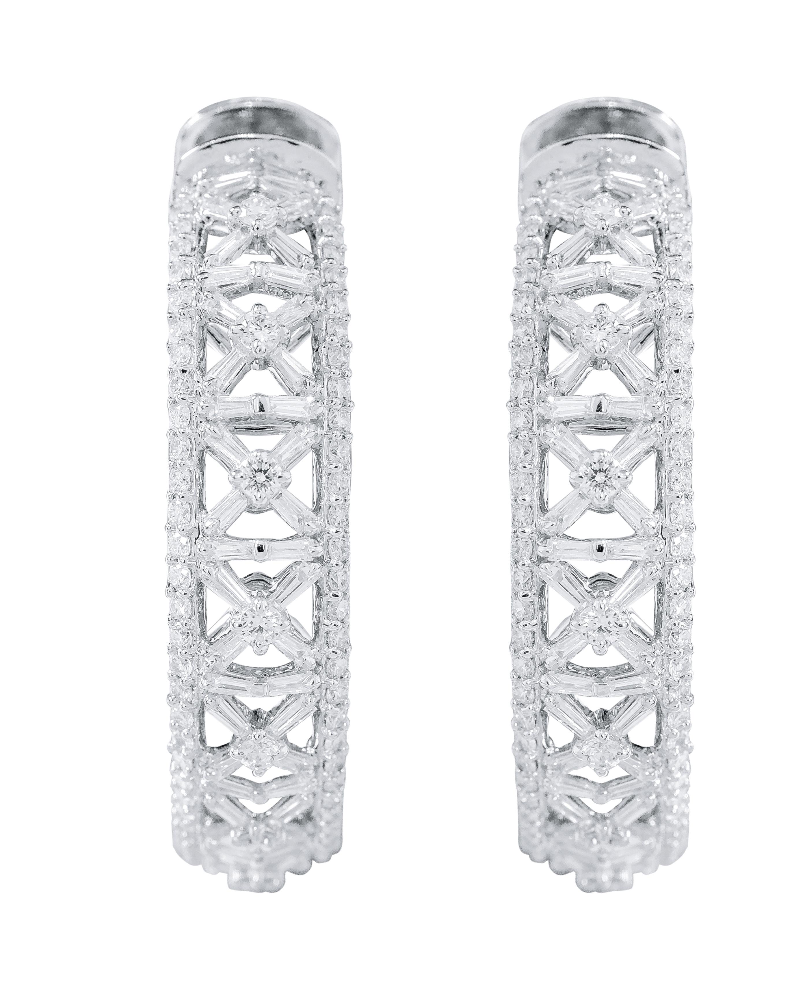 18 Karat White Gold 4.70 Carat Diamond Hoop Earrings

This adorable and glamorous criss-cross hoop earring with the combination of baguette-cut and brilliant-cut diamonds is a splendid design idea. The angled baguette identically sized diamonds