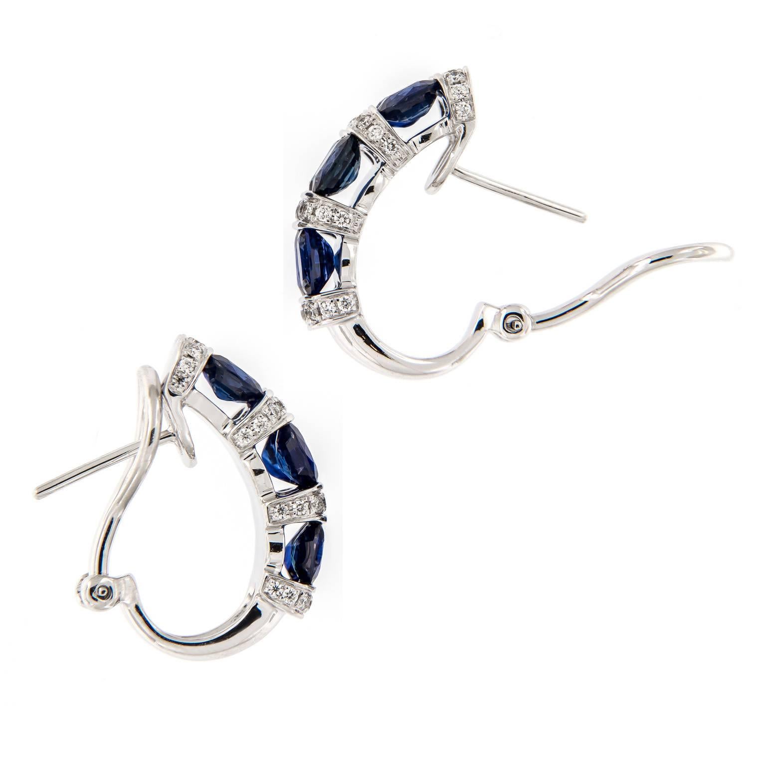 Elegantly stunning alternate rows of juicy saturated blue oval sapphires and pave set fine white diamonds create a beautiful look. Earrings are crafted in fine 18k white gold and have posts with omega clip backs for security of wear. Complimentary