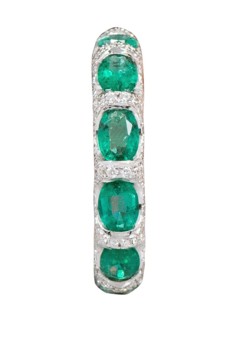 18 Karat White Gold 5.11 Carat Natural Emerald and Diamond Eternity Band Ring 

This glorious vivid green and diamond band is sensational. The solitaire horizontally placed oval shape emeralds are brilliantly enclosed in between pave set round