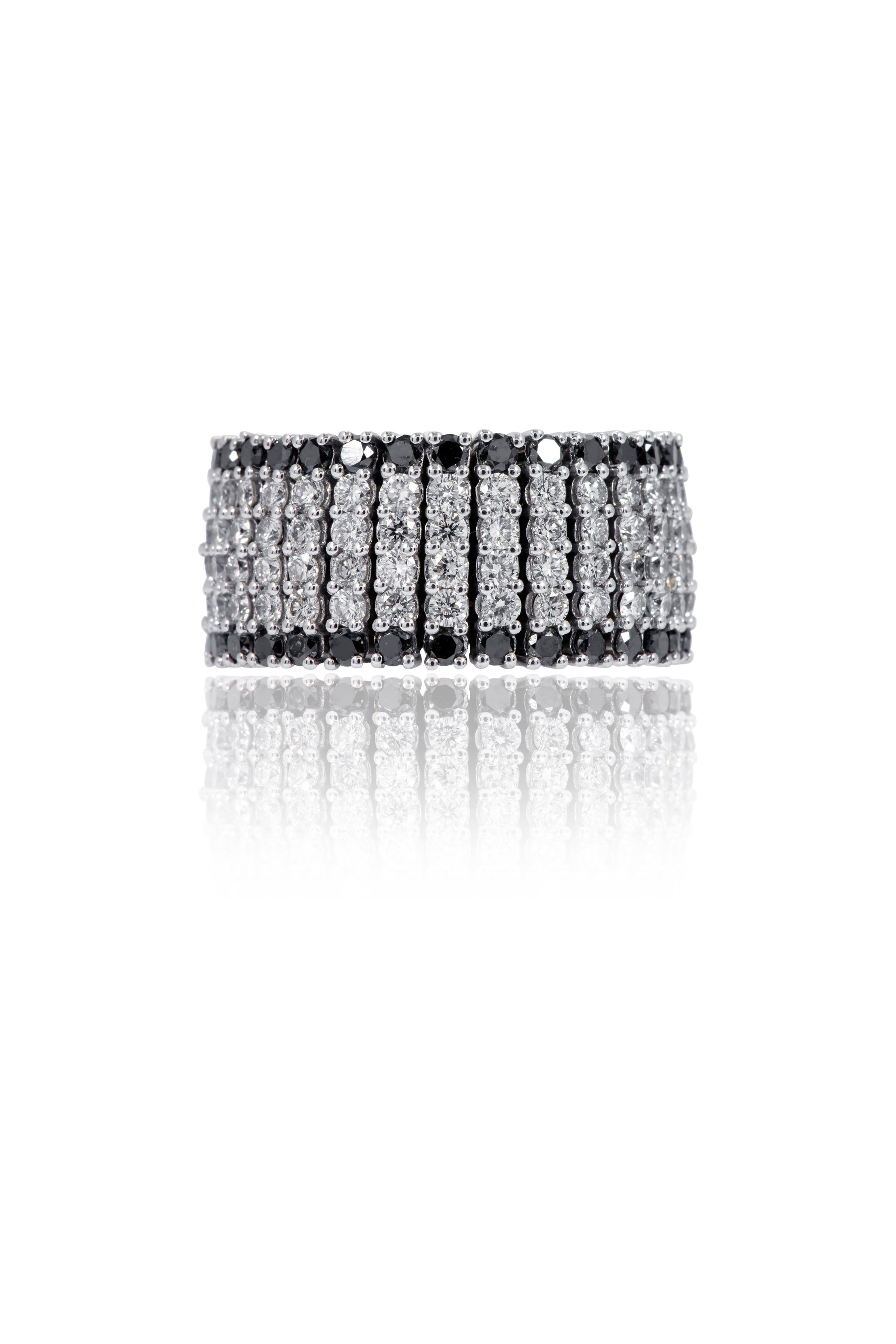 18 Karat White Gold 5.71 Carat White and Black Diamond Flexible Band Ring

This dynamic and rich black and white diamond flexible full band is marvelous. The broad band with three successive white round diamonds and two black round diamonds on