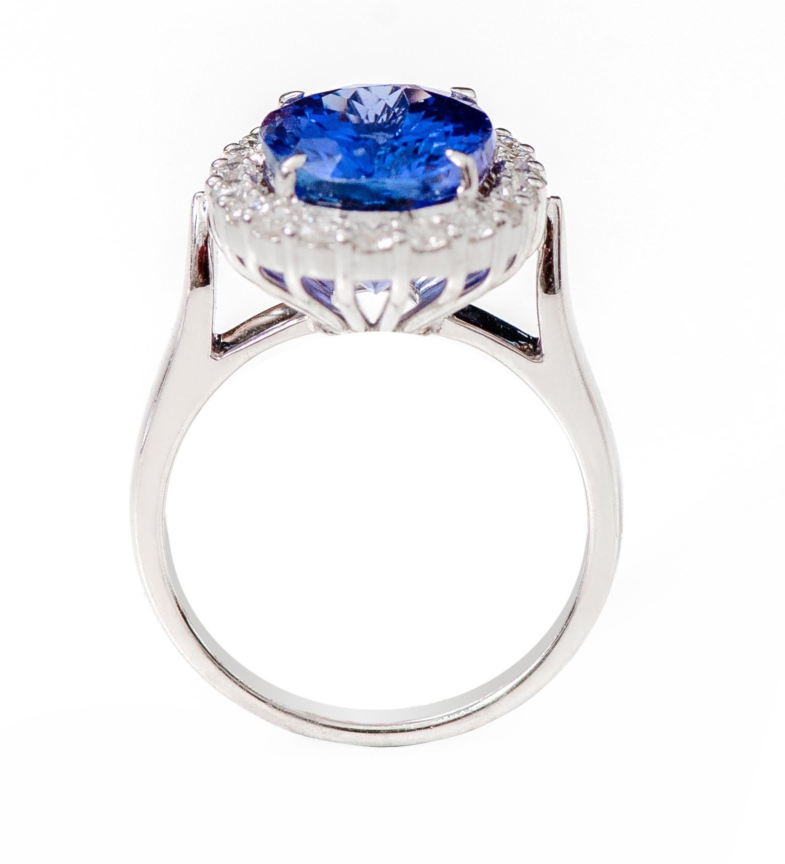 Modern 18 Karat White Gold 6.22 Carat Oval-Cut Tanzanite and Diamond Cluster Ring For Sale