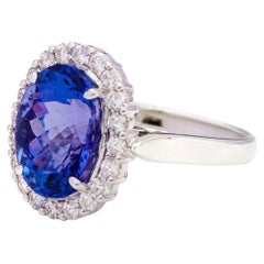 18 Karat White Gold 6.22 Carat Oval-Cut Tanzanite and Diamond Cluster Ring