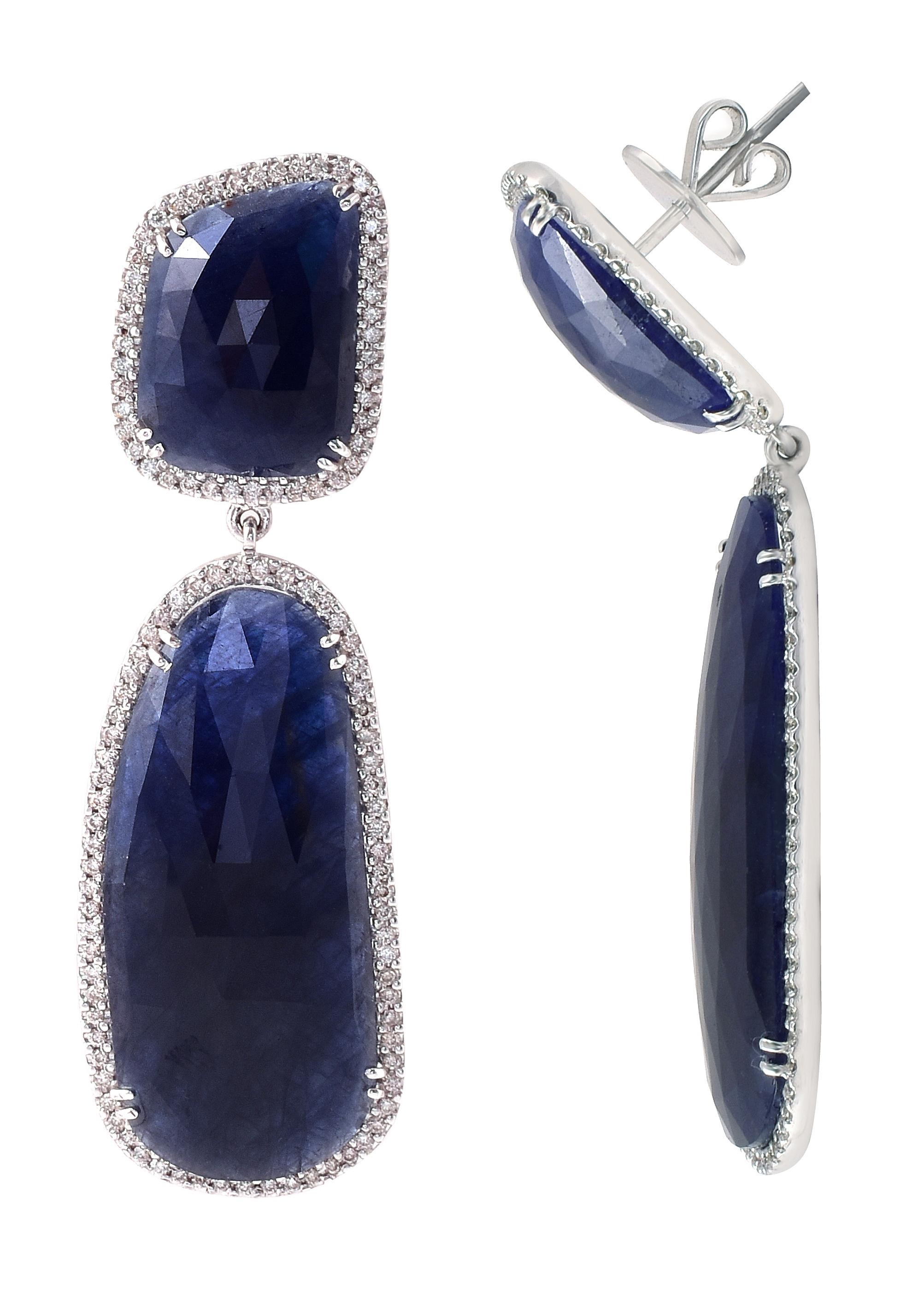 18 Karat White Gold 64.57 Carat Blue Sapphire and Diamond Cocktail Drop Earrings

This incredible cobalt blue sapphire and diamond long slice hanging earring is gorgeous. The solitaire irregular long ovalish-pear cut slice blue sapphire is