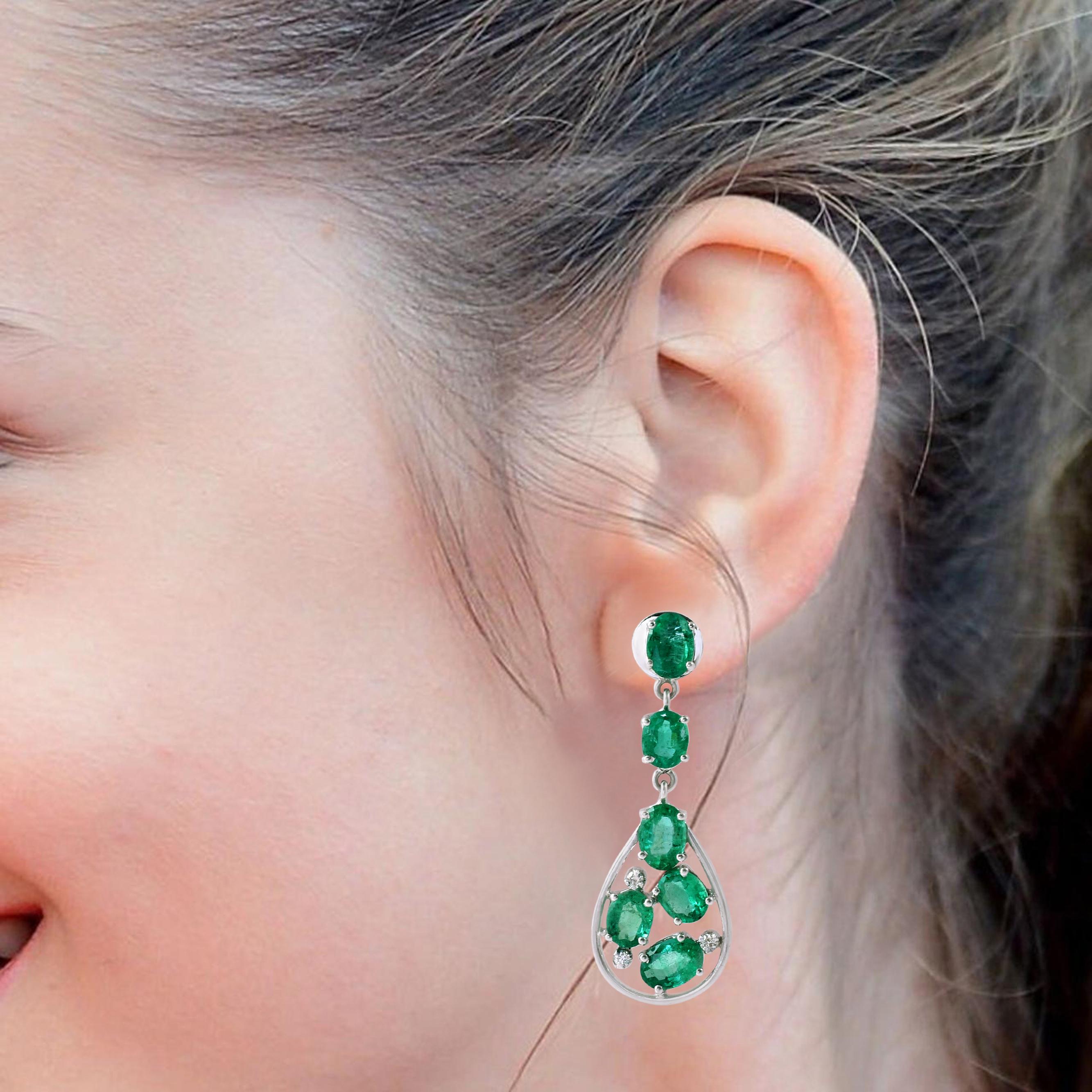 18 Karat White Gold 6.52 Carat Oval-Cut Emerald and Diamond Dangle Earrings

This ingenious forest green emerald and diamond long earring is monumental. The striking open pear shape at the bottom created through the thin white gold border with