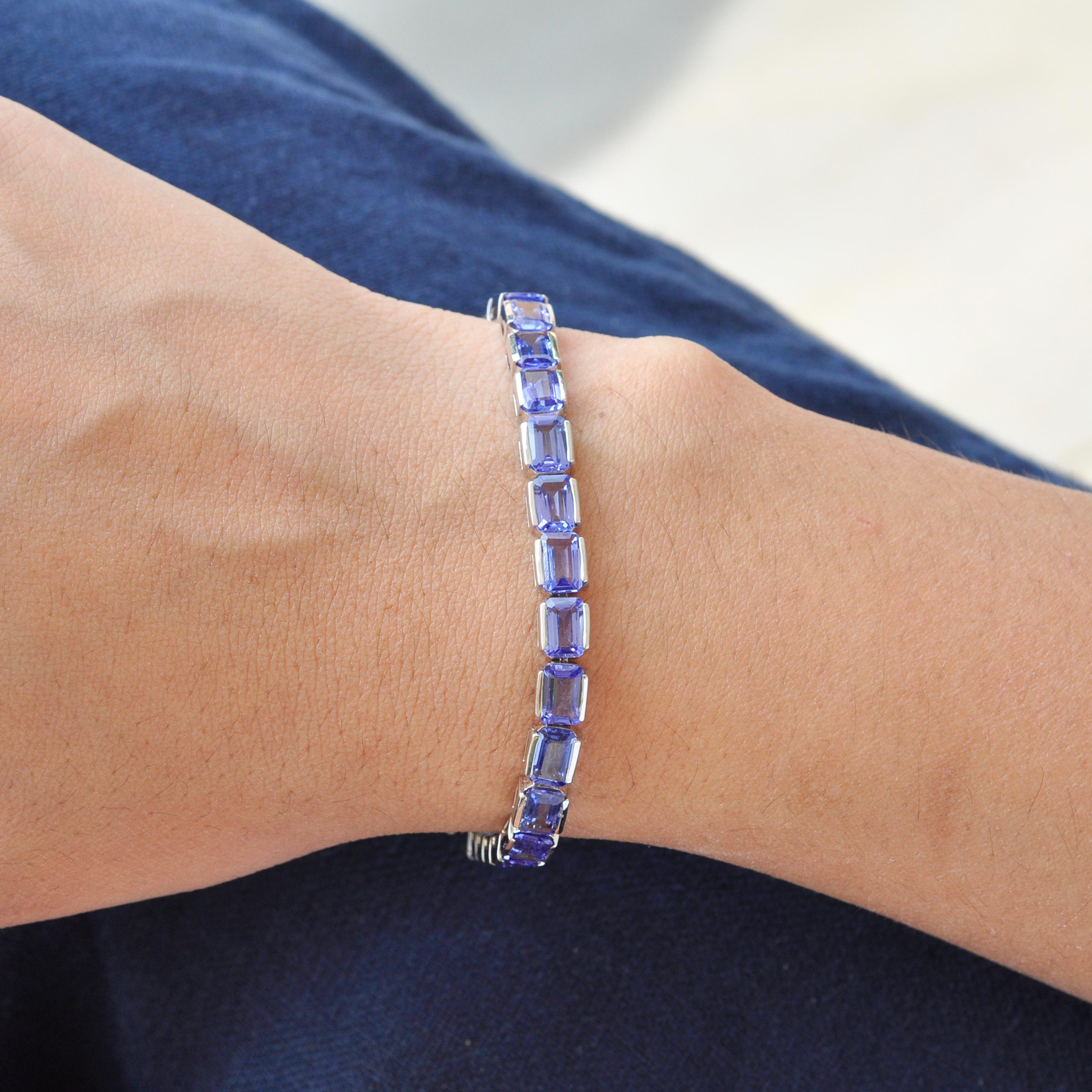 18 karat white gold 6x4mm octagon natural tanzanite tennis line bracelet.

This lustrous vivid blue with a tint of violet natural tanzanite tennis line bracelet is full of life. The identical 29 matching octagon tanzanite of size 6x4 mm each set in