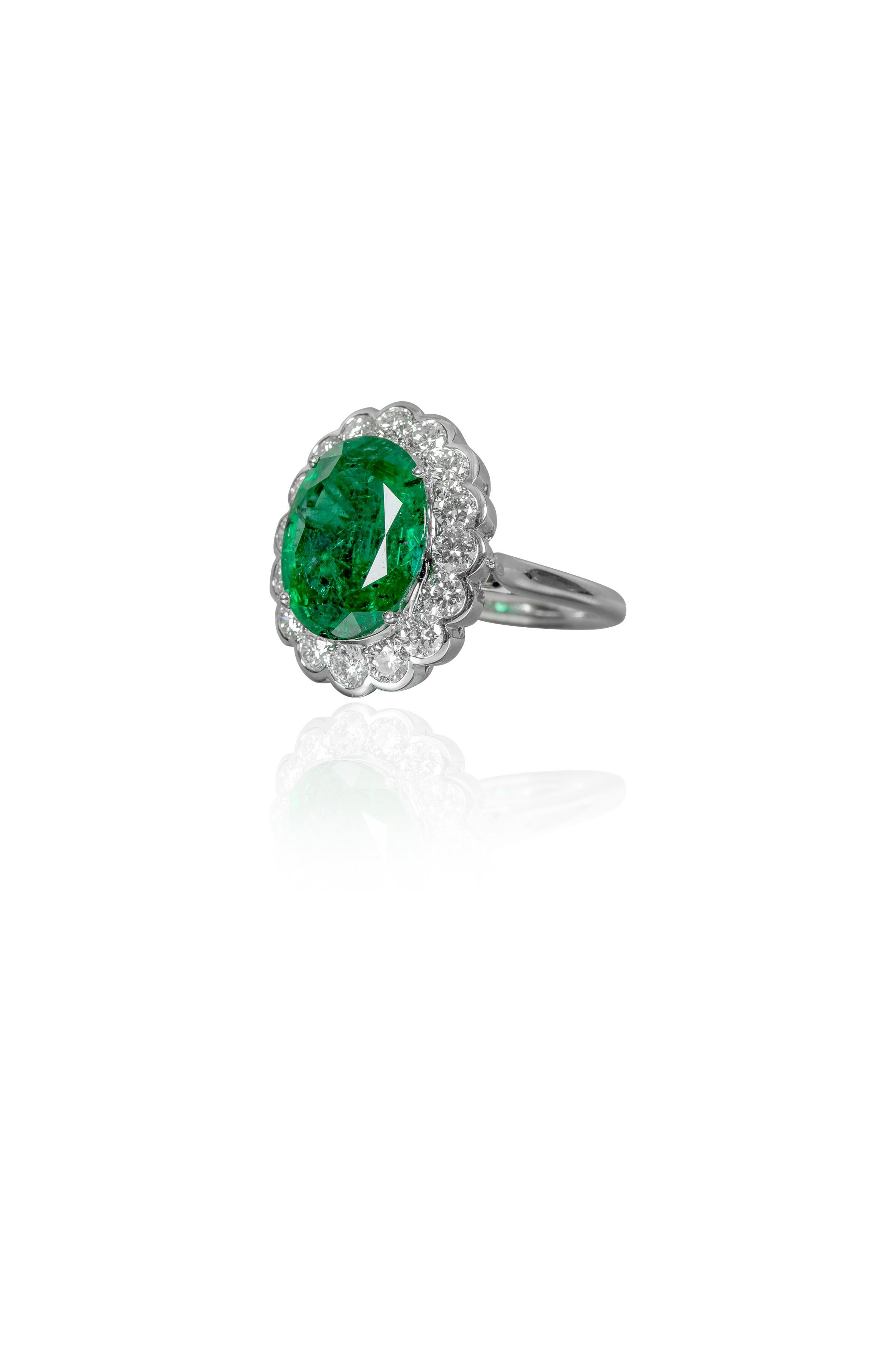 18 Karat White Gold 7.05 Carat Natural Emerald and Diamond Cluster Cocktail Ring

This imperial forest green emerald and diamond cluster ring is spectacular. The solitaire long oval shape emerald is brilliantly set in the classic 4-prong grain