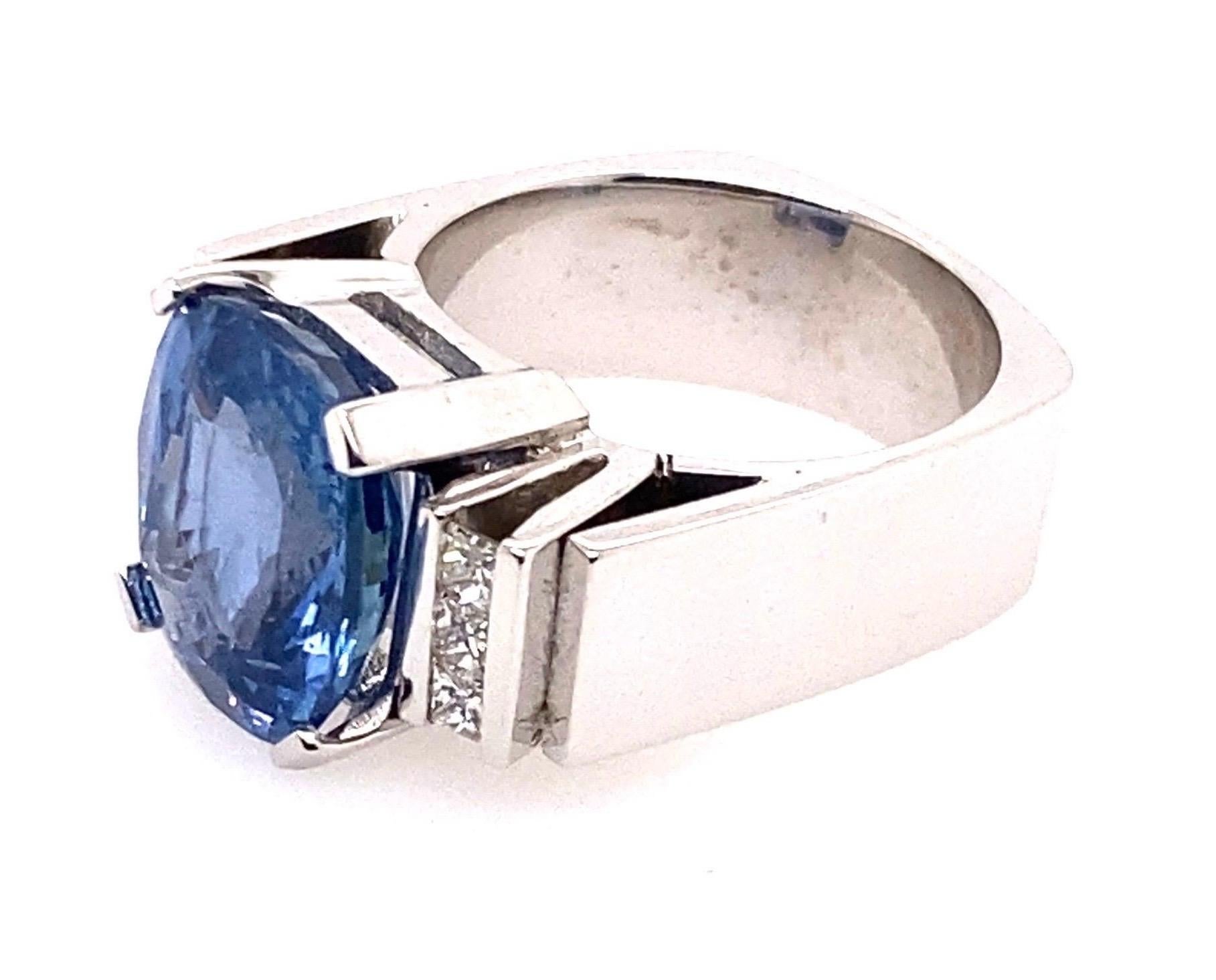 18 Karat White Gold 7.70 Carat Ceylon Blue Sapphire Diamond Ring

Modern handcrafted design 18kt white gold ring. The center stone is a cushion cut blue sapphire secured in a four claw setting. Additional 6 square princess cut diamonds are held in