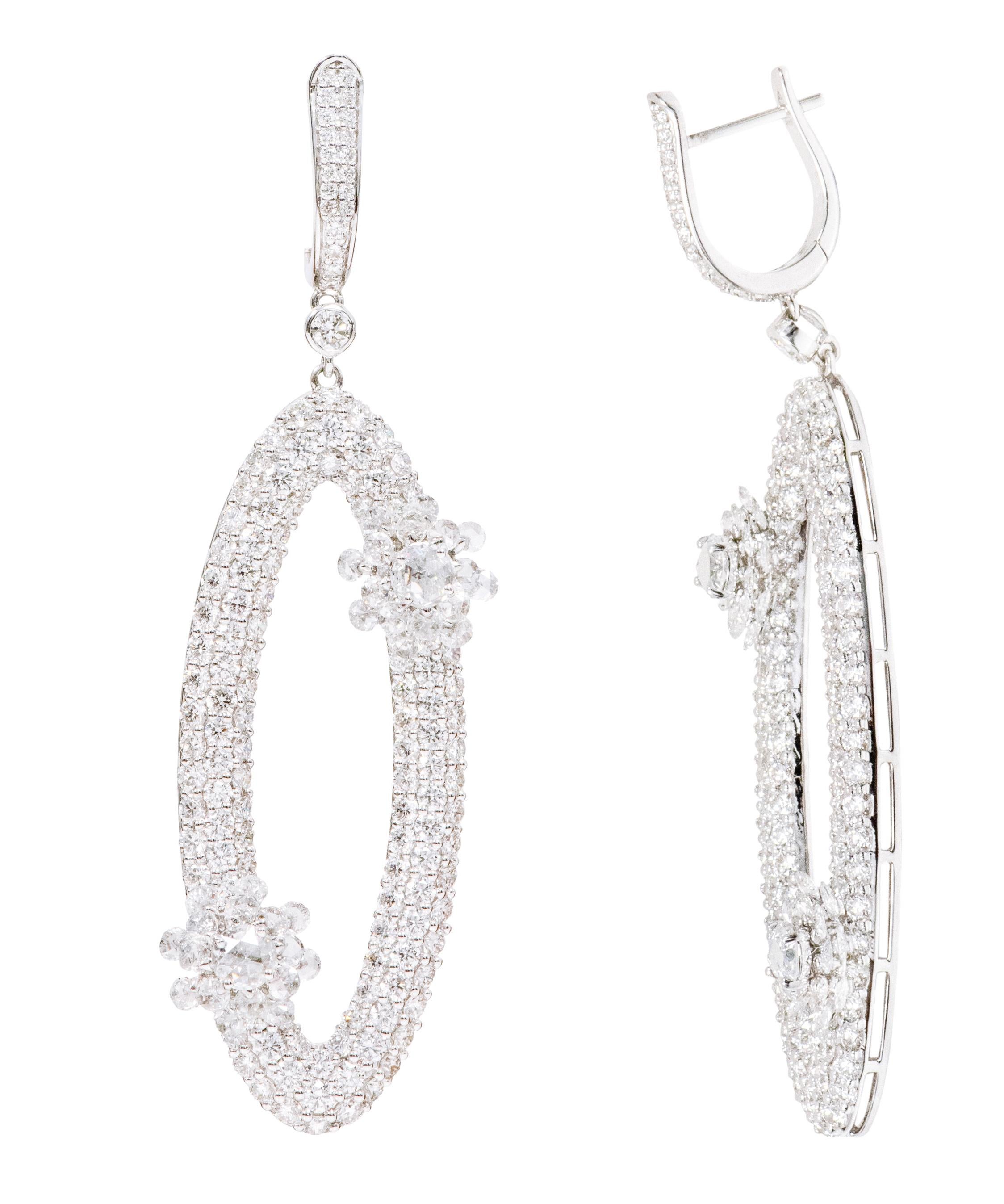 18 Karat White Gold 7.99 Carats Diamond Dangle Cocktail Earrings

This ingenious diamond long earring is exquisite. The hollow curved oval shape of the earring creating a tube is covered with three pave set rows of round diamonds making the look