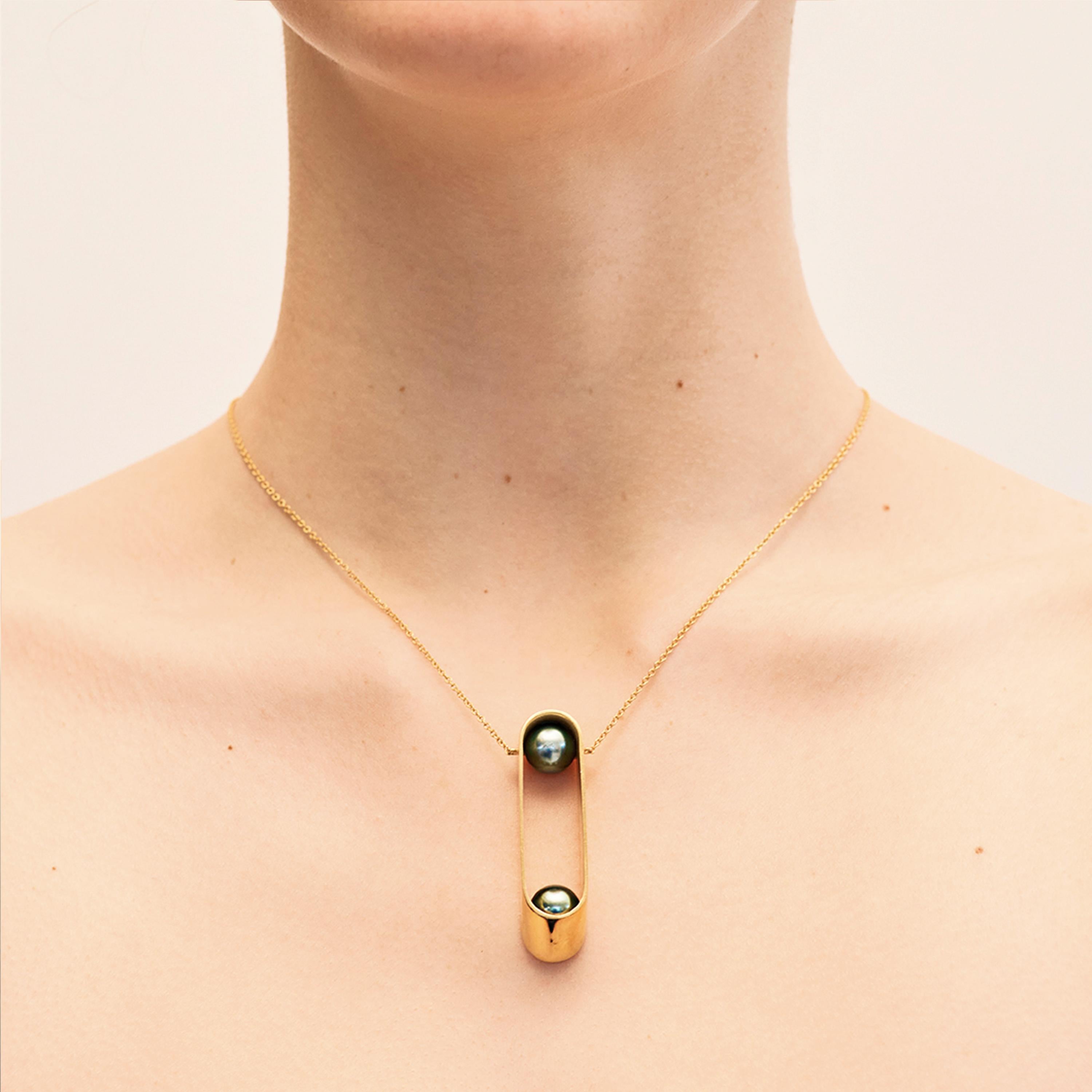 Yael Sonia’s Ellipse Brilliant Necklace is crafted from rhodium plated 18 karat white gold and diamonds (0.04ct). Stationed at opposite ends, two iridescent 8mm Tahitian pearls lend an air of elegance to the sleek elliptical gold pendant. This