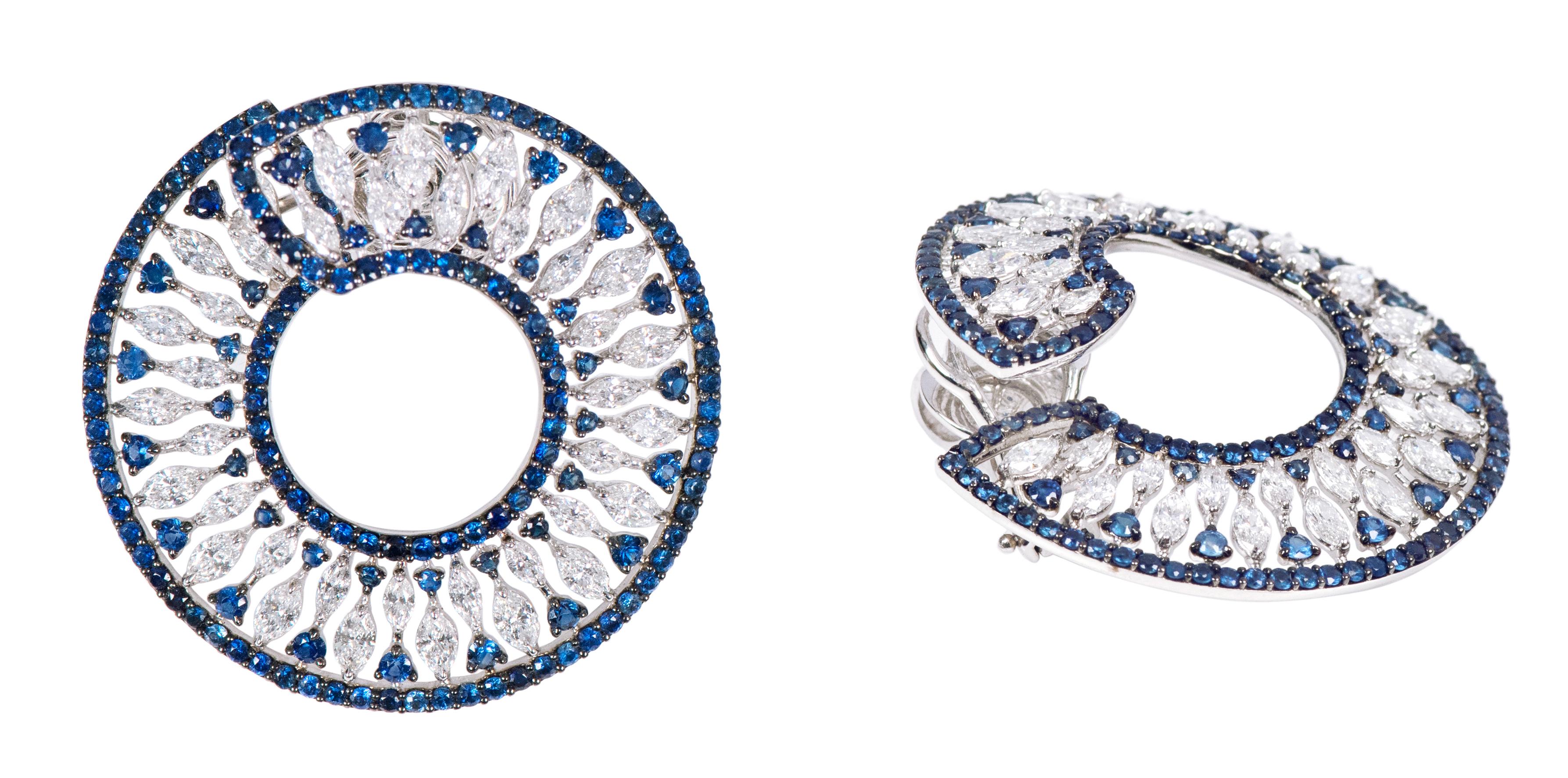 18 Karat White Gold 9.15 Carat Sapphire and Diamond Cocktail Stud Hoop Earrings

This remarkable royal blue sapphire and diamond modern hoop earring is sensational. The round pave set sapphires form the inner and outer layer of this contemporary