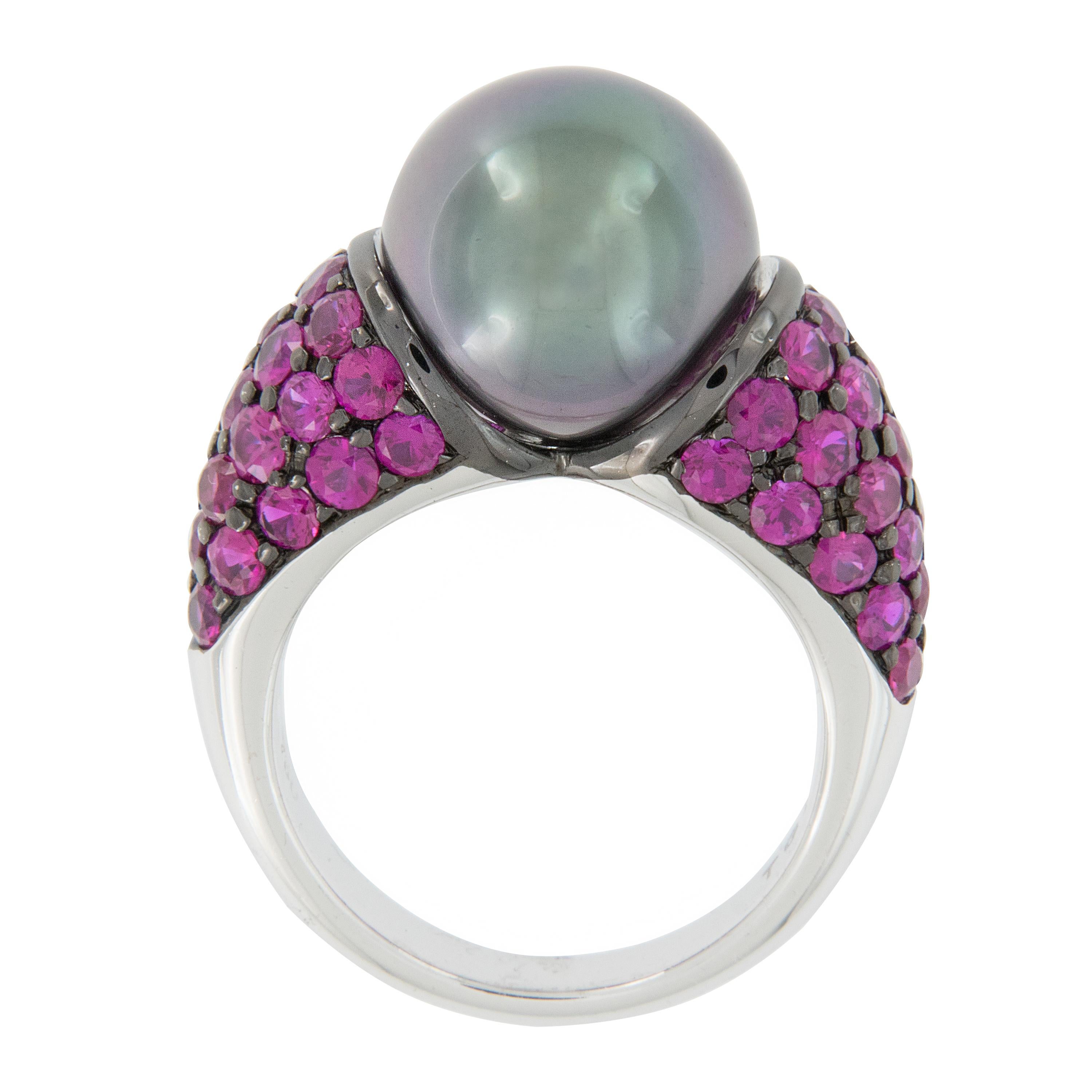 How HOT is this gorgeous ring crafted in 18 karat white gold? The spectacular grey Tahitian pearl with multi hued overtones is showcased by over 3 carats of HOT pink sapphires set in a Bombe' style. Ring is a size 6.5 but can be sized up or down 1
