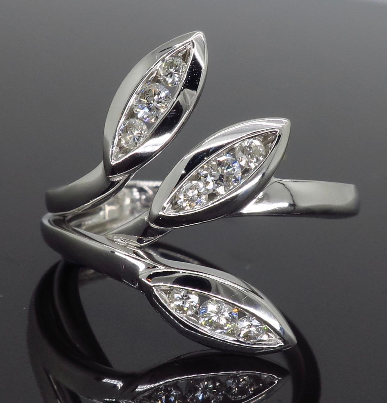 This 18K white gold diamond ring features 9 round brilliant cut diamonds set into a unique asymmetrical design. 

Diamond Cut: 9 Round Brilliant Cut 
Average Diamond Color: G-J
Average Diamond Clarity:  SI-I
Diamond Carat Weight:  .31CTW
Metal: 18K