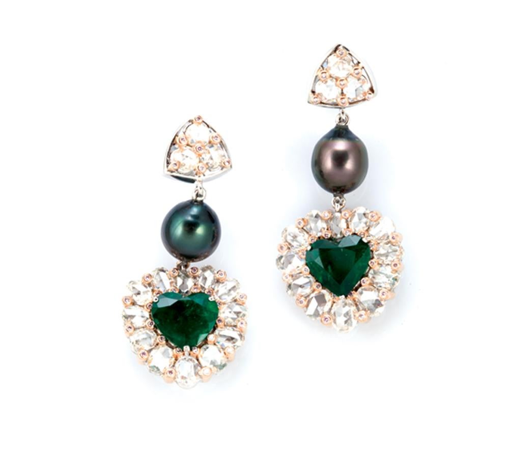 Philosophy and architecture together inspire these earrings that pay tribute to the mystical All Seeing Eye. A series of oval rose-cut and pink diamonds surrounding the heart shaped 6.4-carat emerald denote the All Seeing Eye and the light that